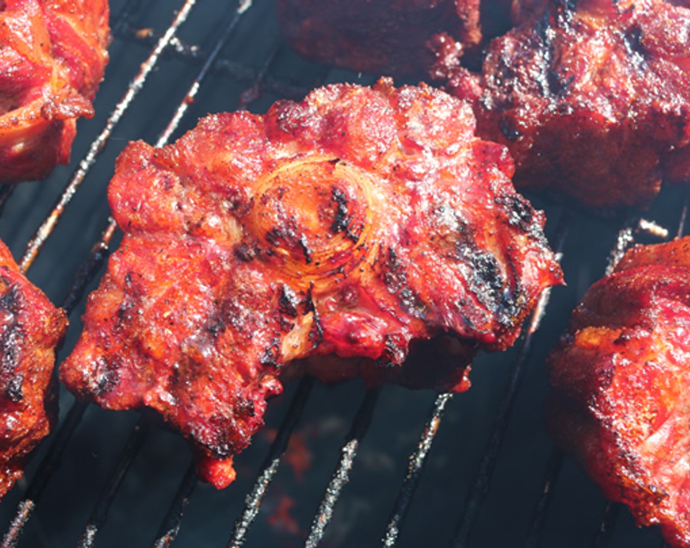 step 7 Place oxtails on cooking rack and smoke for 2 hours, or until outside develops a dark mahogany color.