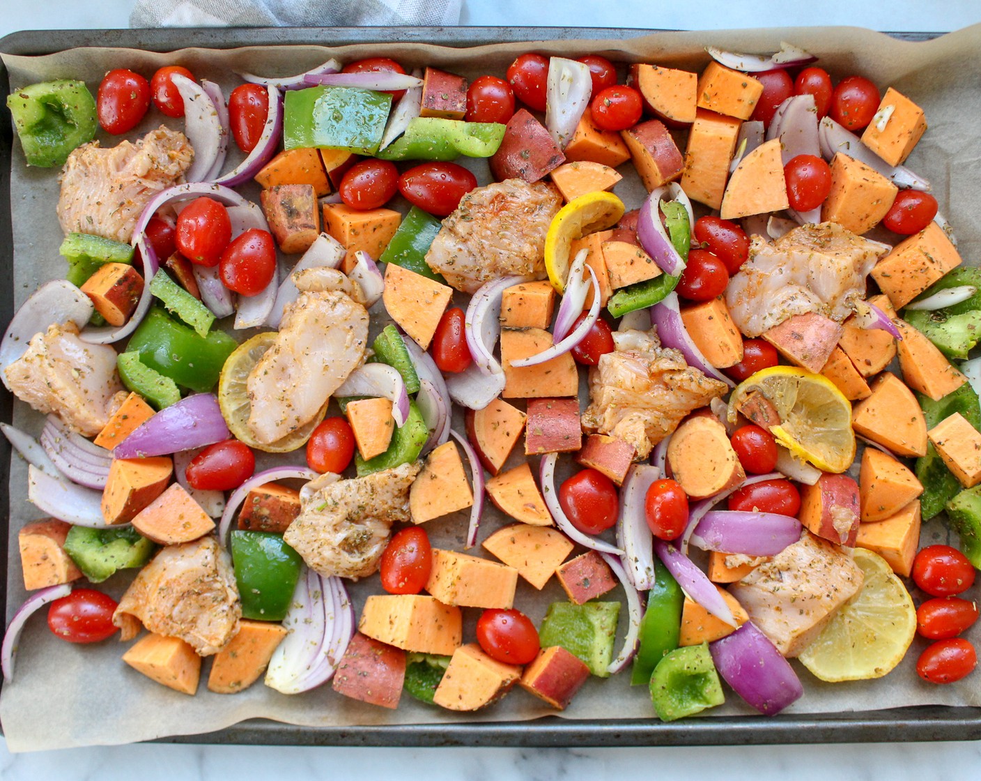 step 5 Add remaining veggies and chicken to the baking sheet after the first 20 minutes and continue cooking at 375 degrees F (190 degrees C) for 20 minutes, until the internal temperature of the chicken reaches 165 degrees F (75 degrees C) and the vegetables are soft to bite.