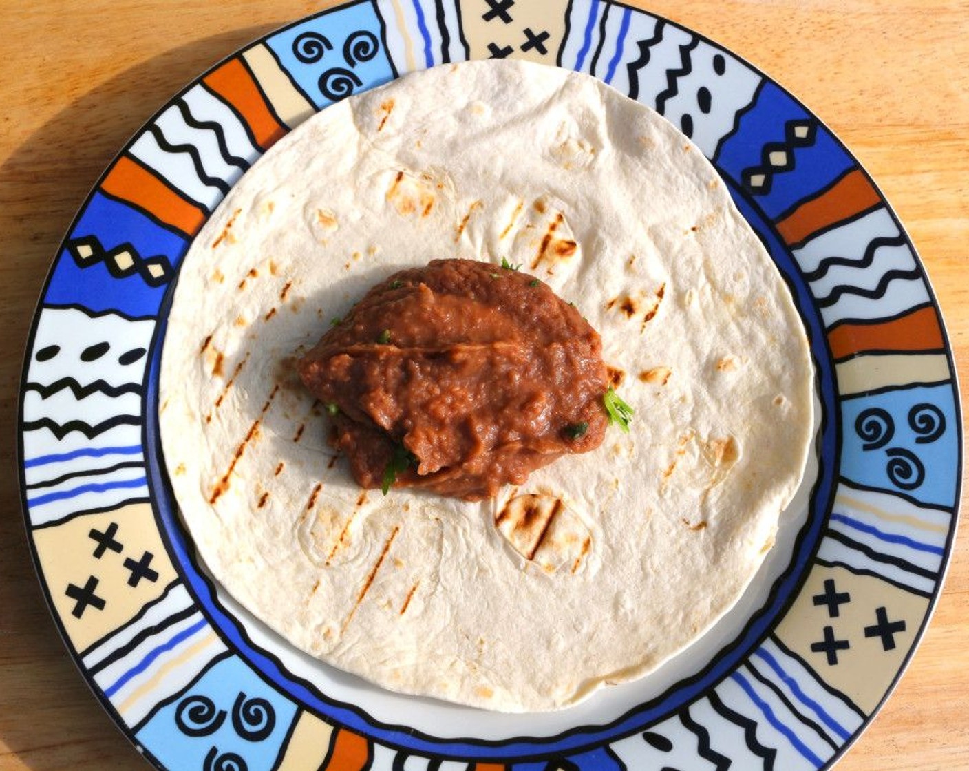 step 5 Top each Flour Tortillas (to taste) with 2 Tbsp of Refried Beans (to taste).