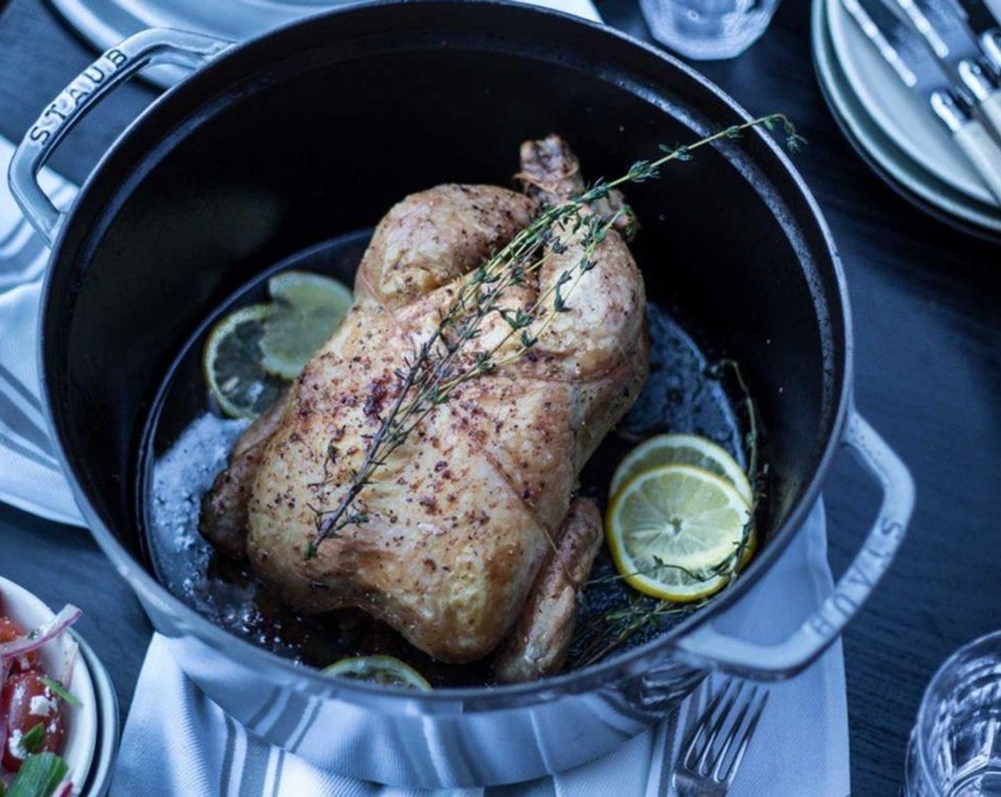 step 9 Remove from oven. With the bird still in the Dutch oven or skillet, add 2-4 sprigs of fresh thyme and a few slices of Lemon (1) to the rendered chicken juices.