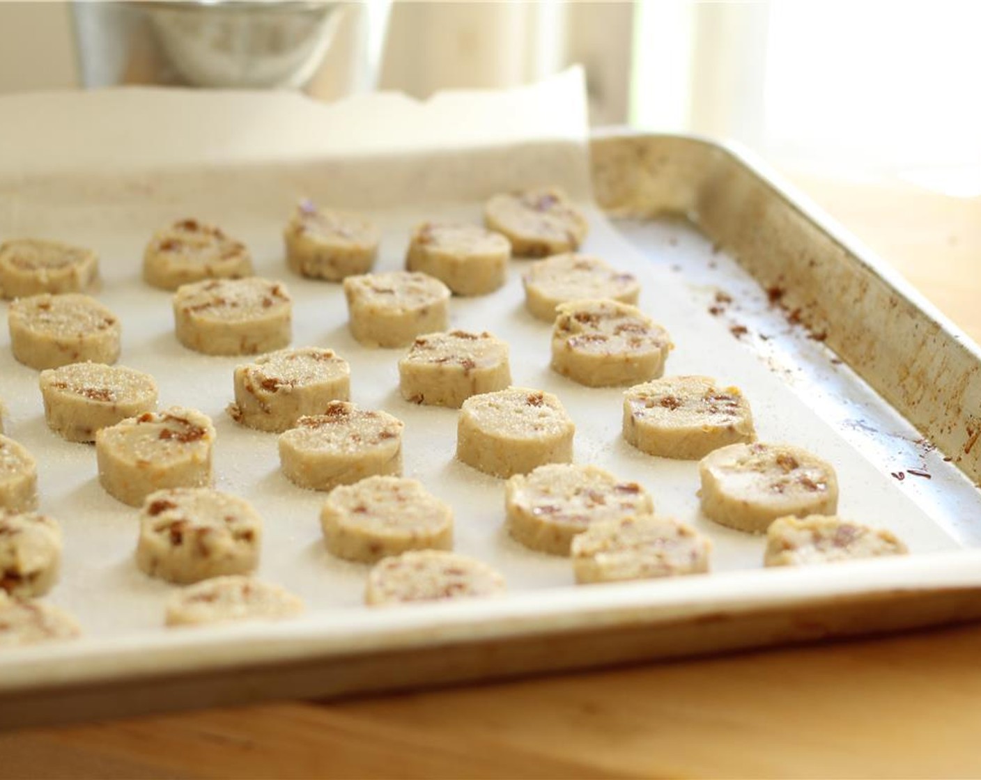 step 14 Unwrap the dough and slice it into 1/2 inch circles. Arrange them on the parchment lined baking sheet and sprinkle with a pinch of the Granulated Sugar (2 Tbsp) - you may not use all of it. Prick the center gently with the tines of a fork.