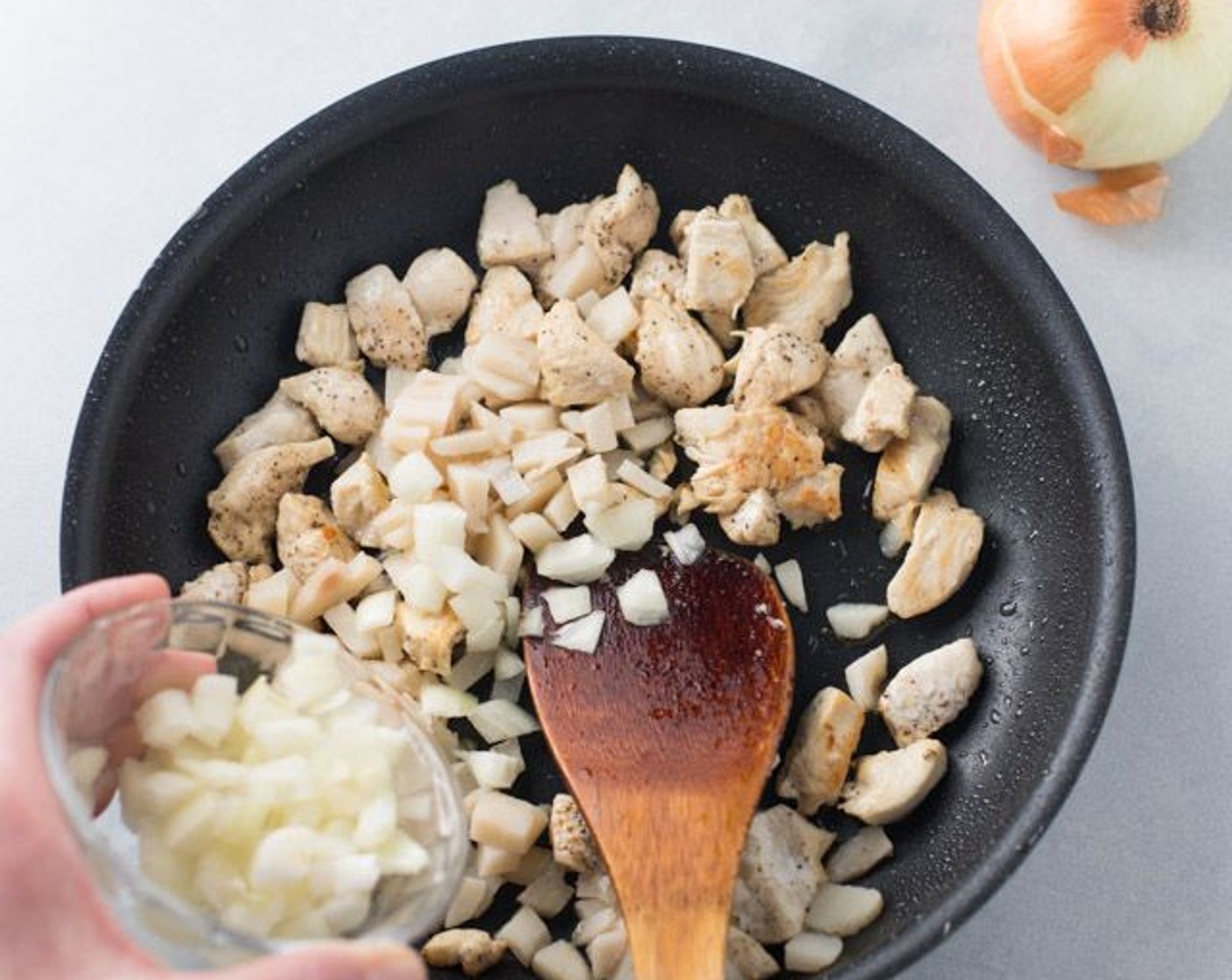 step 3 Add to your pan the Water Chestnuts (1/2 cup) and Onion (1/3 cup) and fry an additional 5 minutes, or until chicken is done. Remove from heat and set aside this filling.