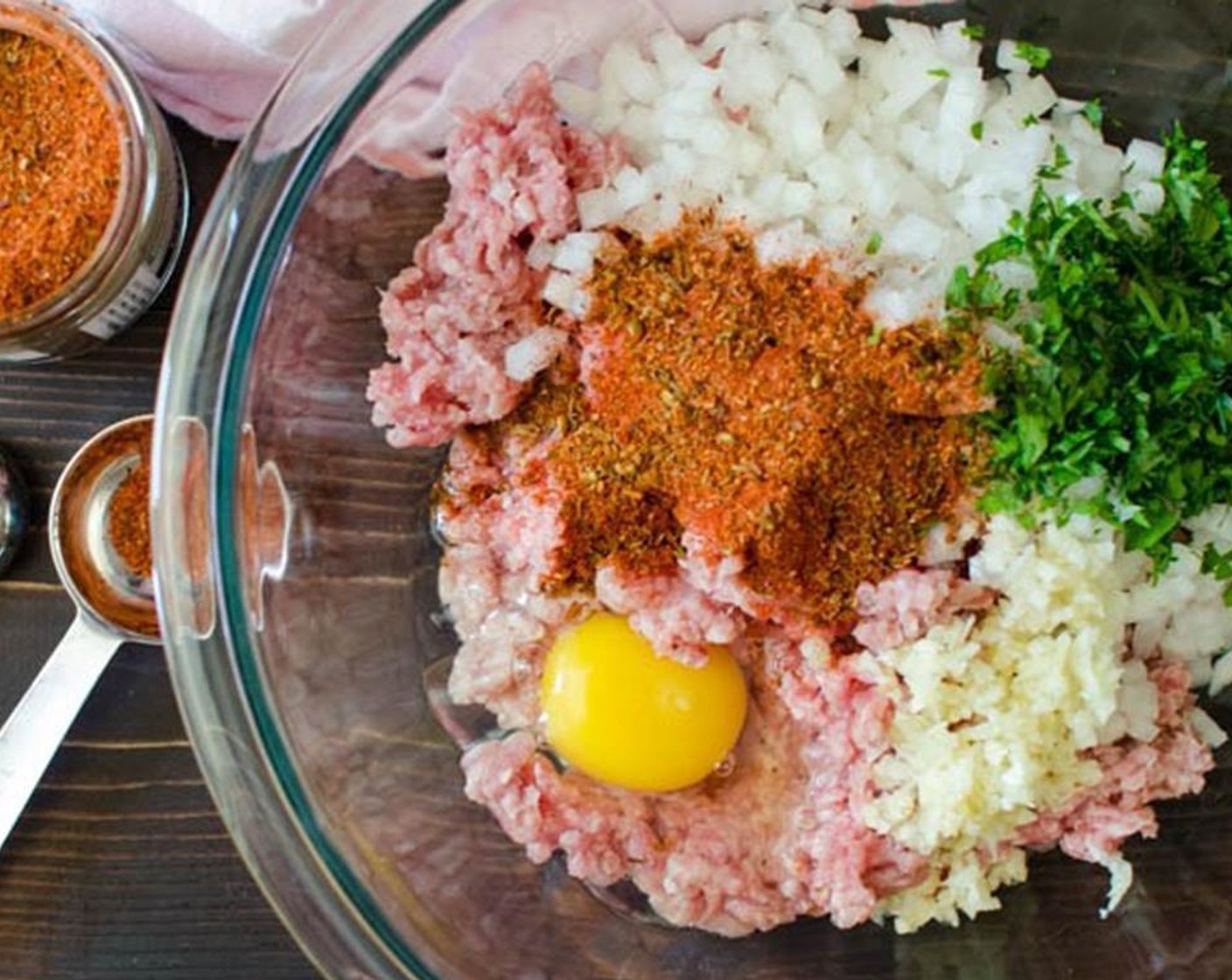 step 1 In a large bowl, combine the Ground Pork (1 lb), Onion (1), Garlic (1 clove), Fresh Parsley (2 Tbsp), Cajun Seasoning (1 Tbsp), and Egg (1). Mix thoroughly with your hands.