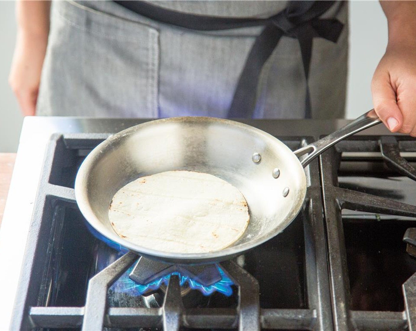 step 16 In a small saute pan over high heat, add the White Corn Tortillas (4) one at a time. Cook on each side for 30 seconds until very hot. Wrap the tortillas in foil and set aside for plating.