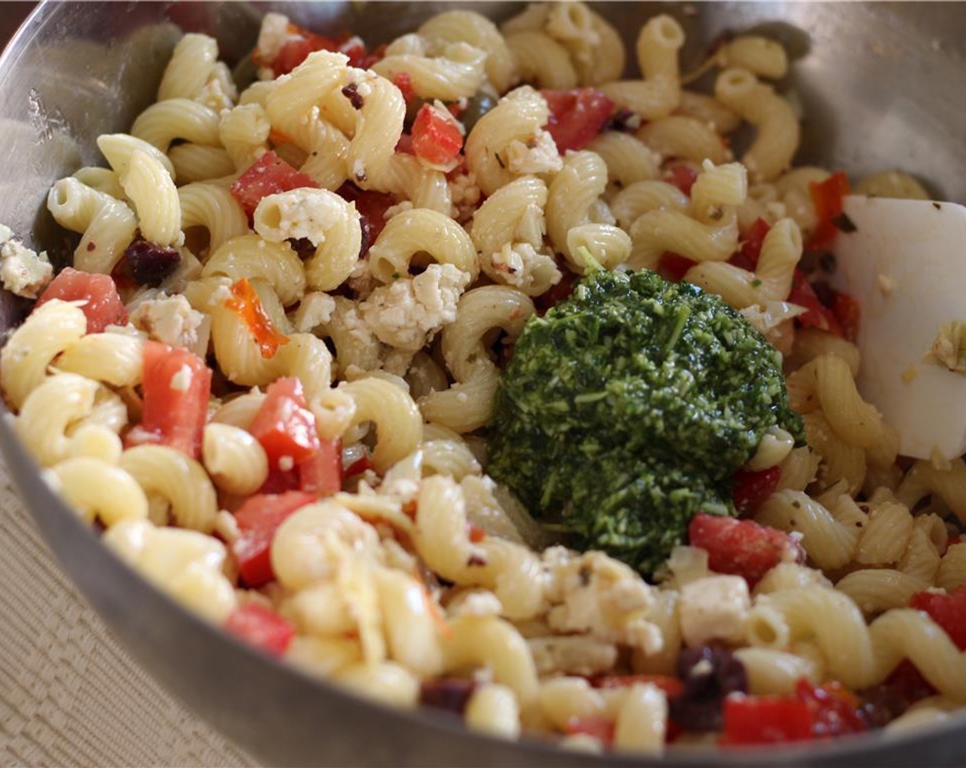 step 4 In a large bowl, combine the pasta, Roma tomatoes, roasted tomatoes, olives, artichokes, Feta Cheese (1/2 cup), and Basil Pesto (1/3 cup).