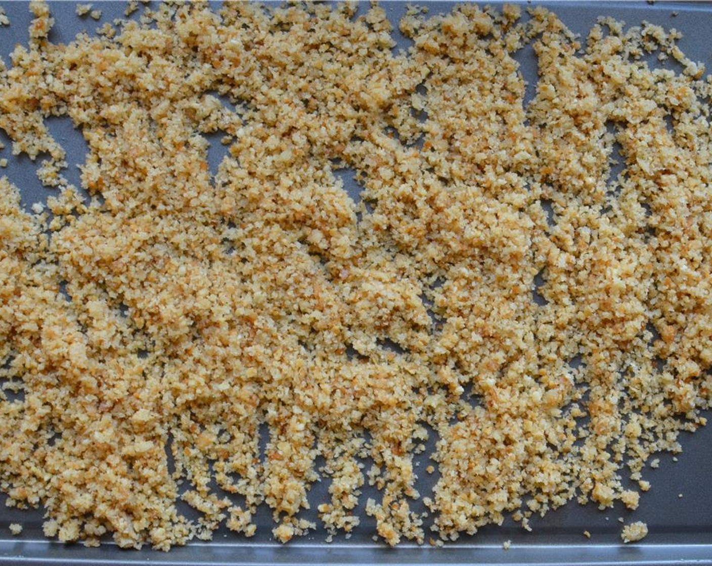 step 4 Scatter the crumbs on a cookie sheet and pop into the preheated oven for about 3 to 5 minutes. Keep a close eye on those crumbs and stir them around, you want them lightly toasted not browned or burned! Then transfer the crumbs to a shallow dish.