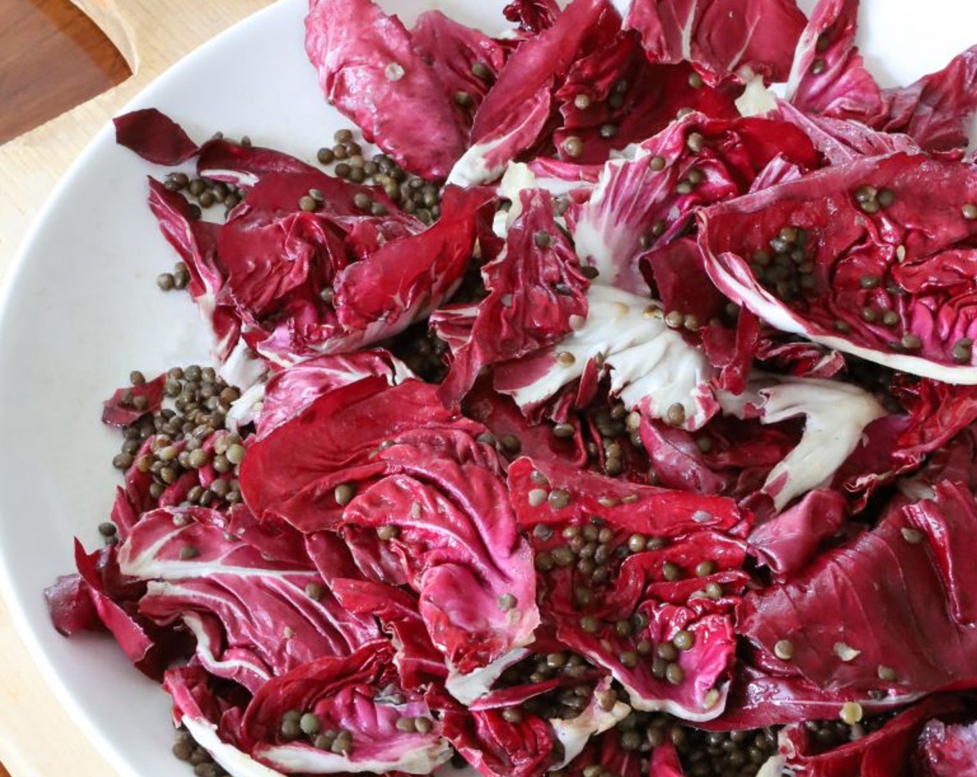 step 6 Add Radicchio Leaf (1 head) to the platter with the lentils, drizzle with half the remaining dressing, and toss. Set aside until the lentils are completely cool. If using arugula, wait until just before serving to toss with the greens with the lentils and dressing.