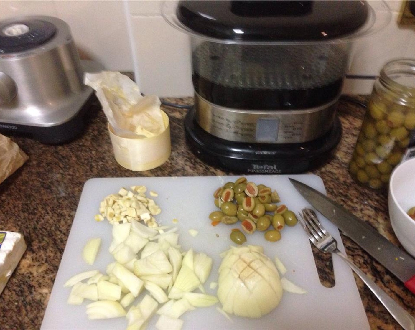 step 2 Roughly chop the Onion (1) and Garlic (6 cloves). Halve the Pimento Stuffed Green Olives (1 1/4 cups). Reserve a 1/4 cup of the olives for garnish later.