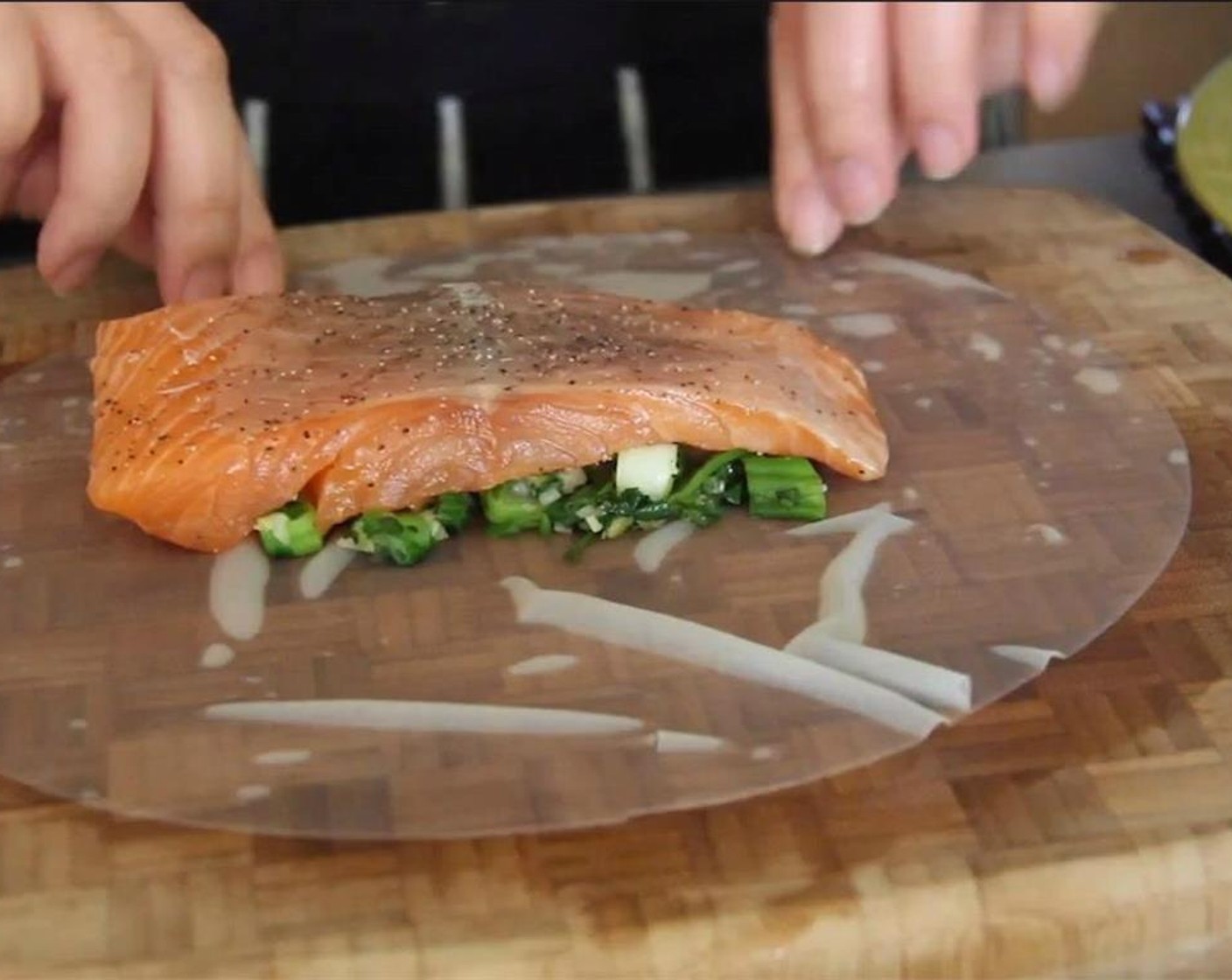 step 14 Place salmon on top, and tightly fold ends of the rice paper up and around the salmon to make it a package, like you're making a burrito.