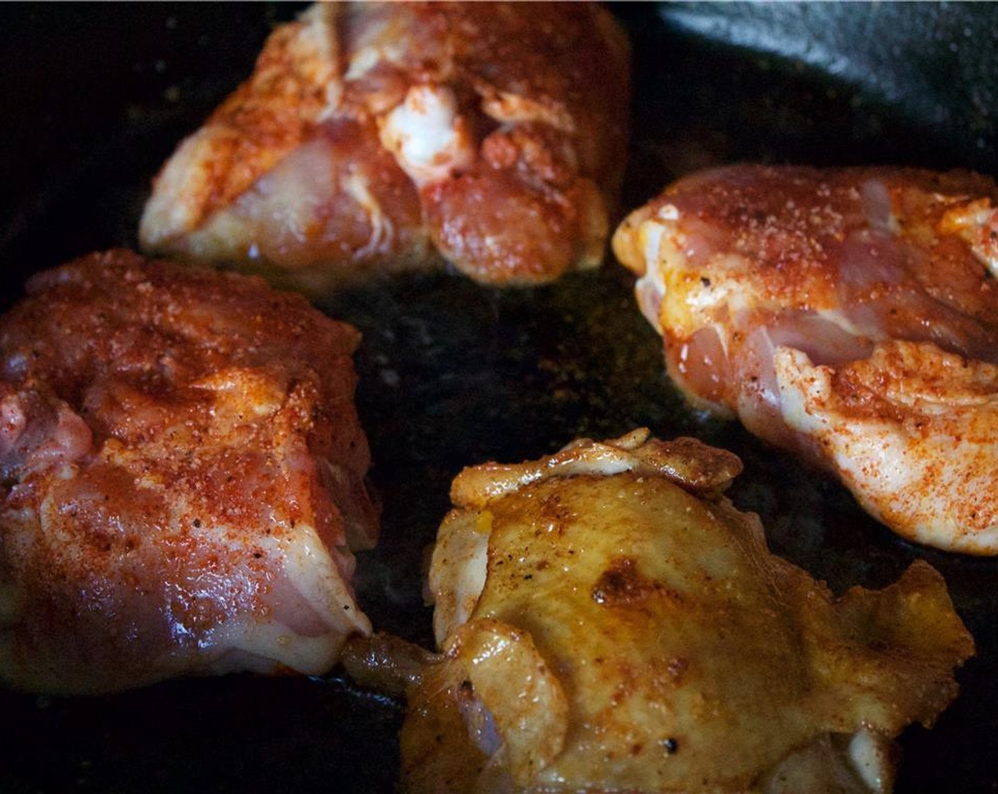 step 7 Place the cast iron over medium-high heat and add in Canola Oil (1 Tbsp). Once smoking, add the thighs to the pan. Sear on each side until golden, 4 to 6 minutes per side.