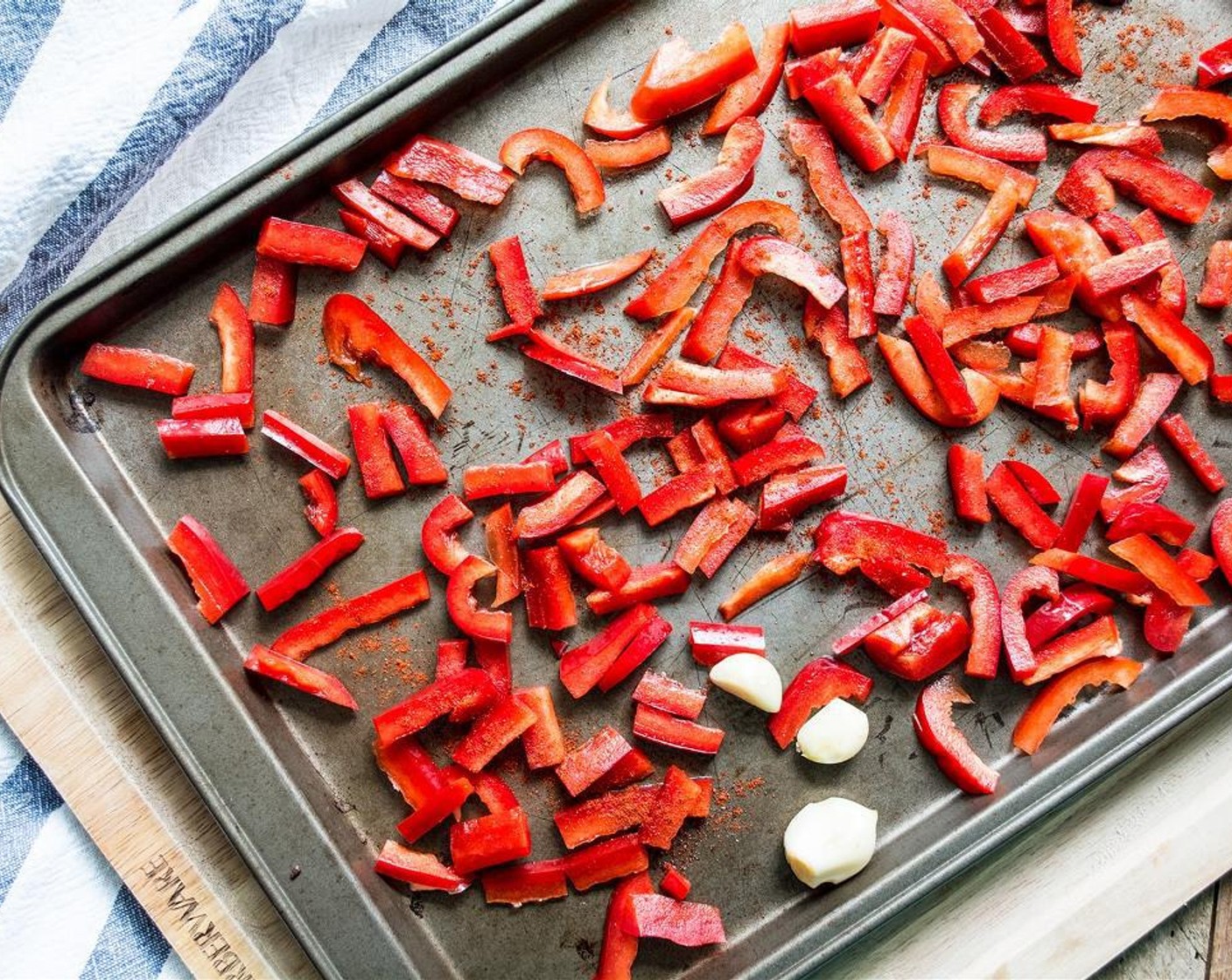 step 2 Spray pan with nonstick cooking spray and spread Red Bell Pepper (1) evenly across pan in single layer. Add Garlic (3 cloves) then lightly sprinkle peppers and garlic with Smoked Paprika (to taste) and roast in oven for 18 minutes.