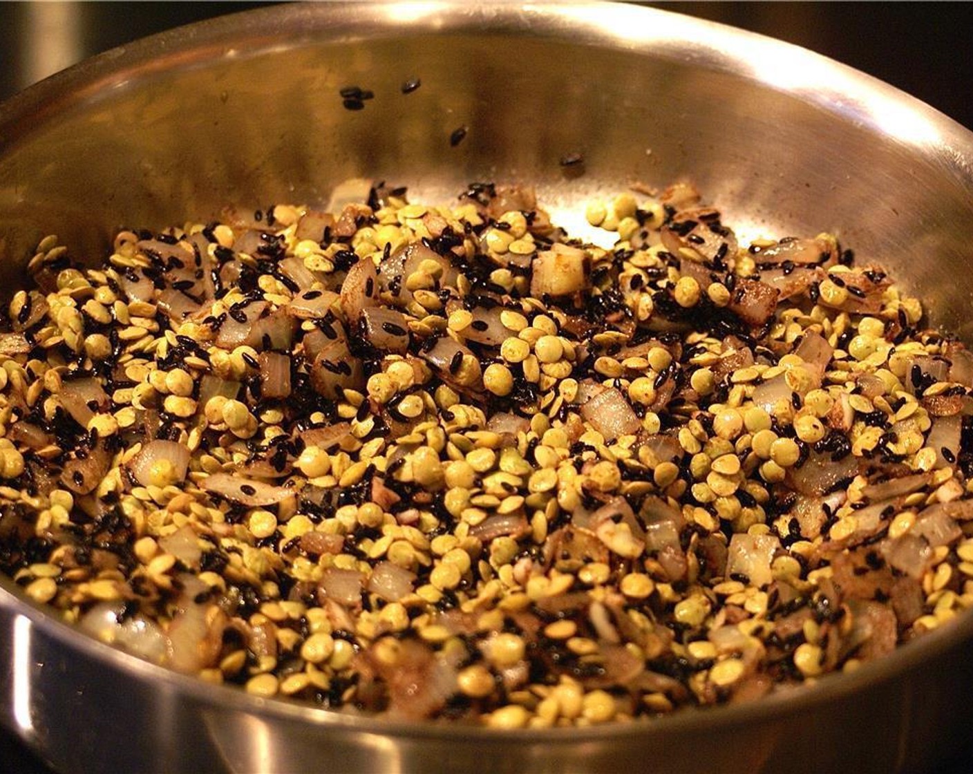 step 4 While letting the dry rice and spices cook, drain lentils and add to the pan.