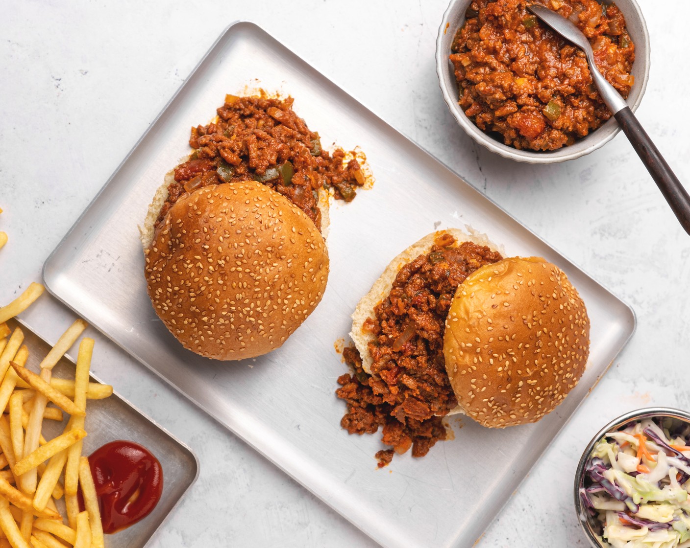 step 5 Serve meat sauce over buns, like a burger. Serve with Coleslaw Mix (to taste), Pickled Cucumbers (to taste), and a side of French Fries (to taste).