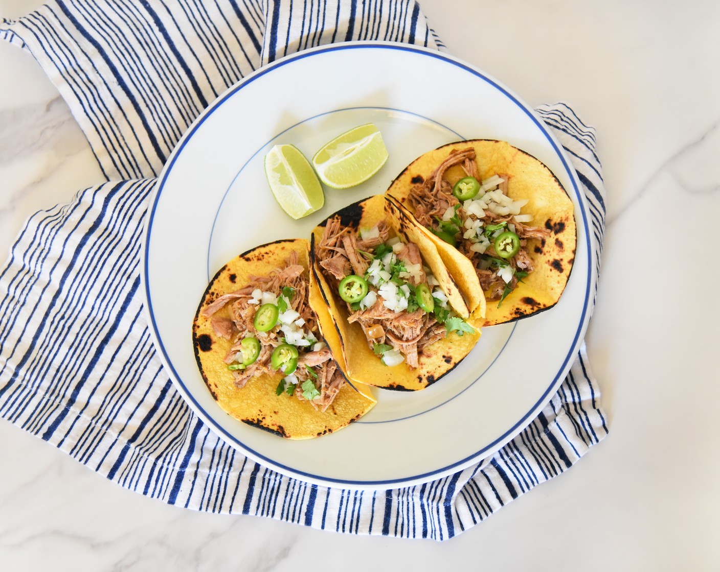 step 6 Once cooked, shred the pork tenderloins in the sauce and serve on Small Corn Tortillas (as needed) with your favorite toppings like Fresh Cilantro (to taste) and Onions (to taste).