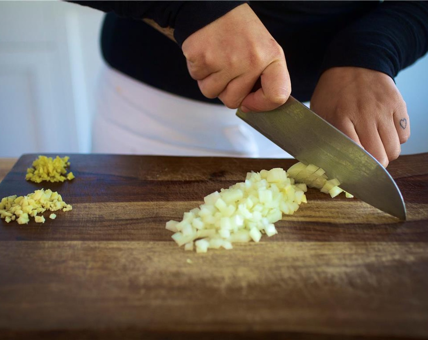 step 2 Mince the Garlic (2 cloves) and place in a small bowl. Peel Fresh Ginger (1 1/3 Tbsp) with a spoon. Mince and add to the bowl. Cut the Onion (1) into a quarter inch dice. Set aside.