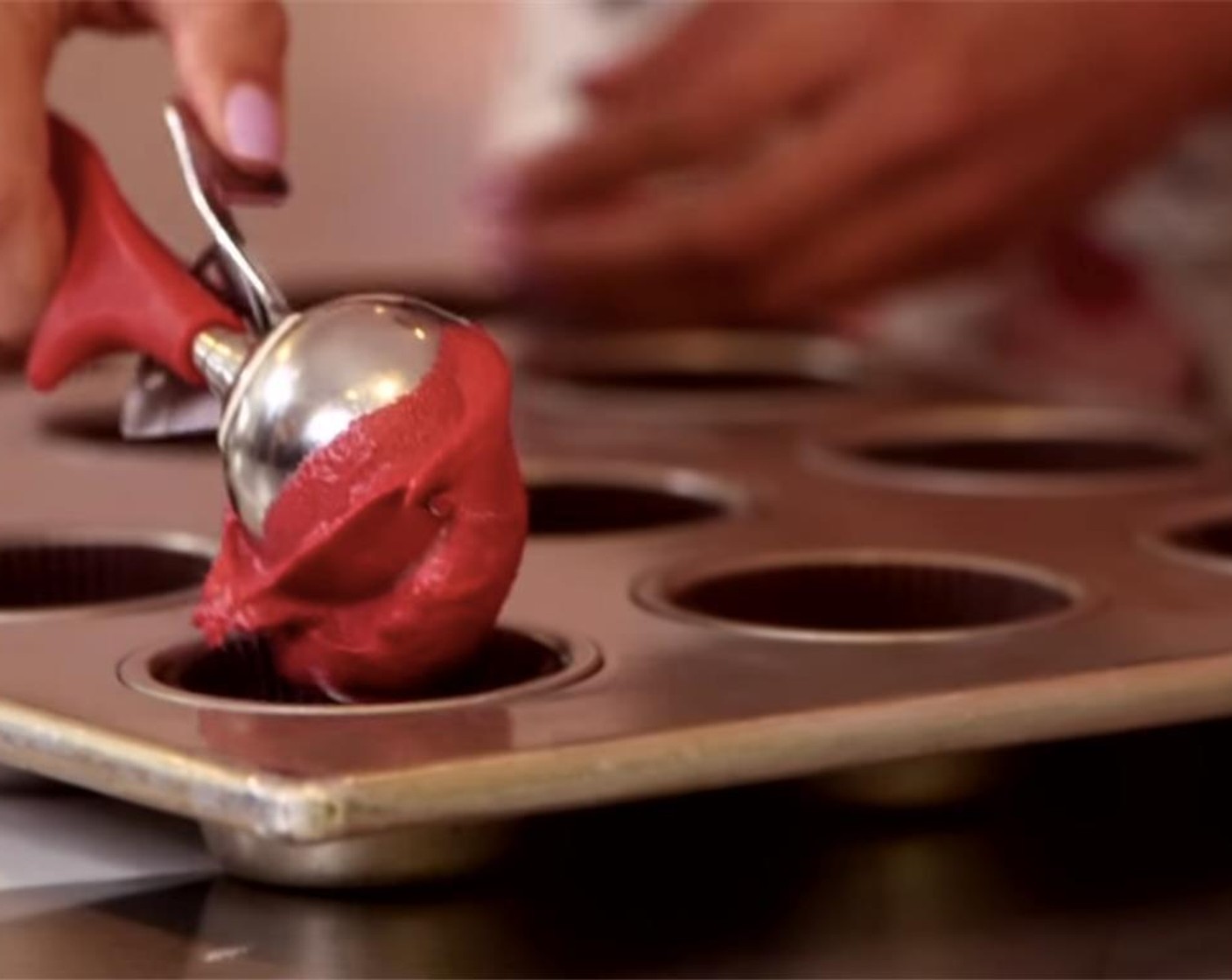 step 9 Using a standard-size, spring-release ice cream scooper, scoop batter into the lined cupcake pans so each well is 2/3 full.