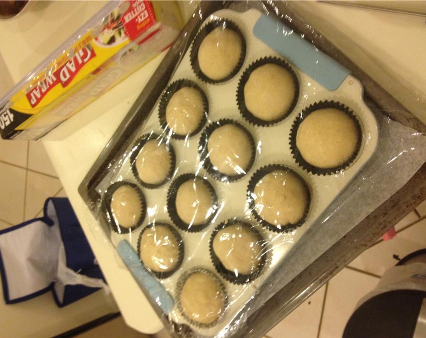 step 16 Put the dough balls into a lined muffin tray. Cover with cling wrap and rest for 45-60 minutes or until doubled in size.