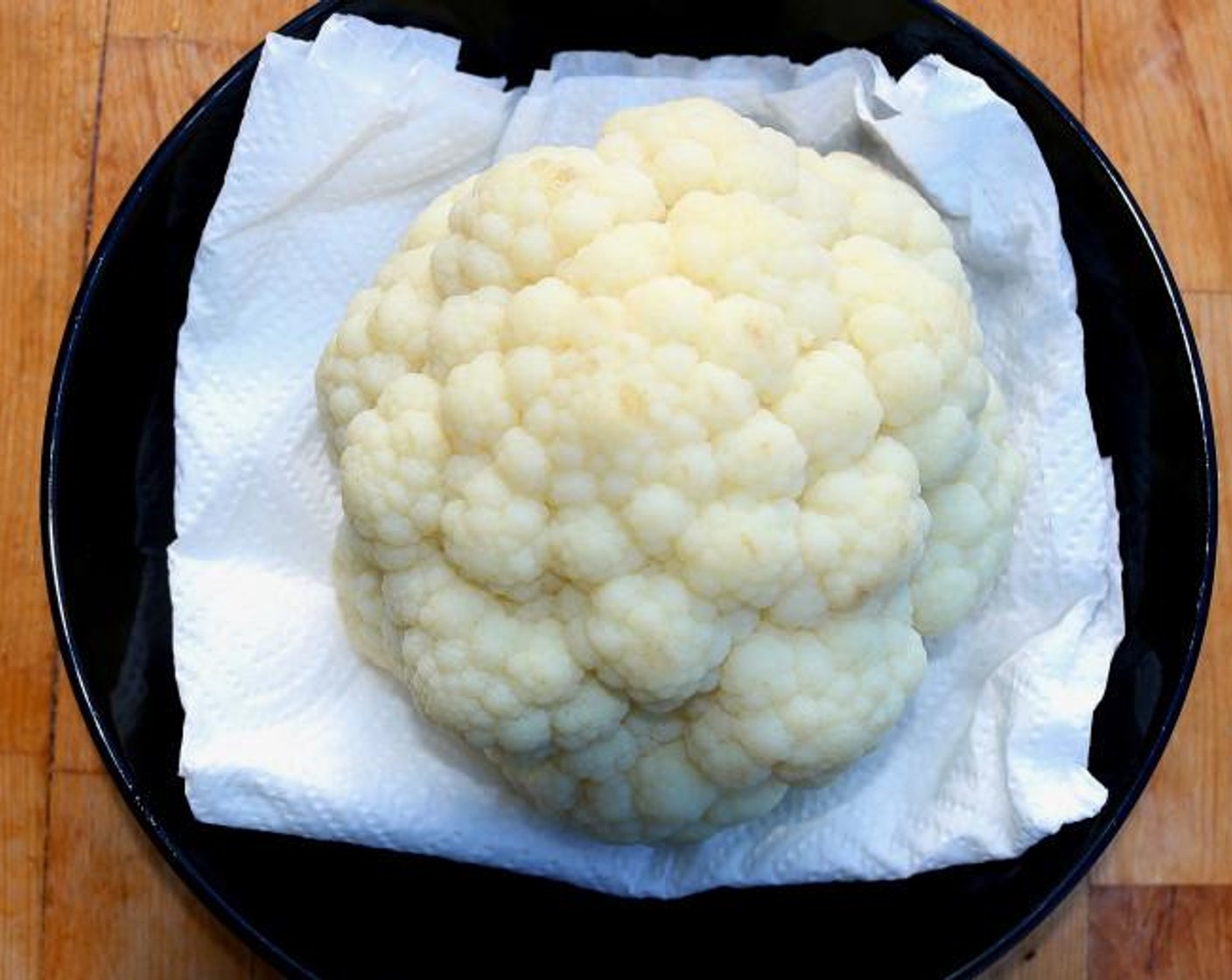step 2 Rest the cauliflower on absorbent paper until dry, about 15 minutes.