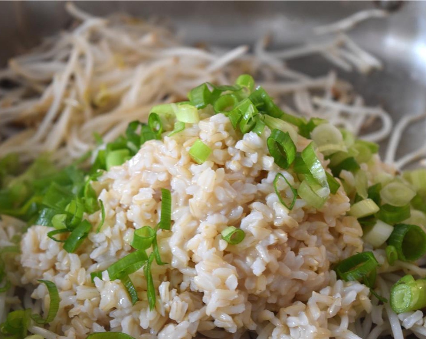 step 6 Add the cooked Brown Rice (2 1/2 Tbsp) and green onions. Mix all ingredients. Heat for 4 minutes stirring occasionally. Add Soy Sauce (1 Tbsp).