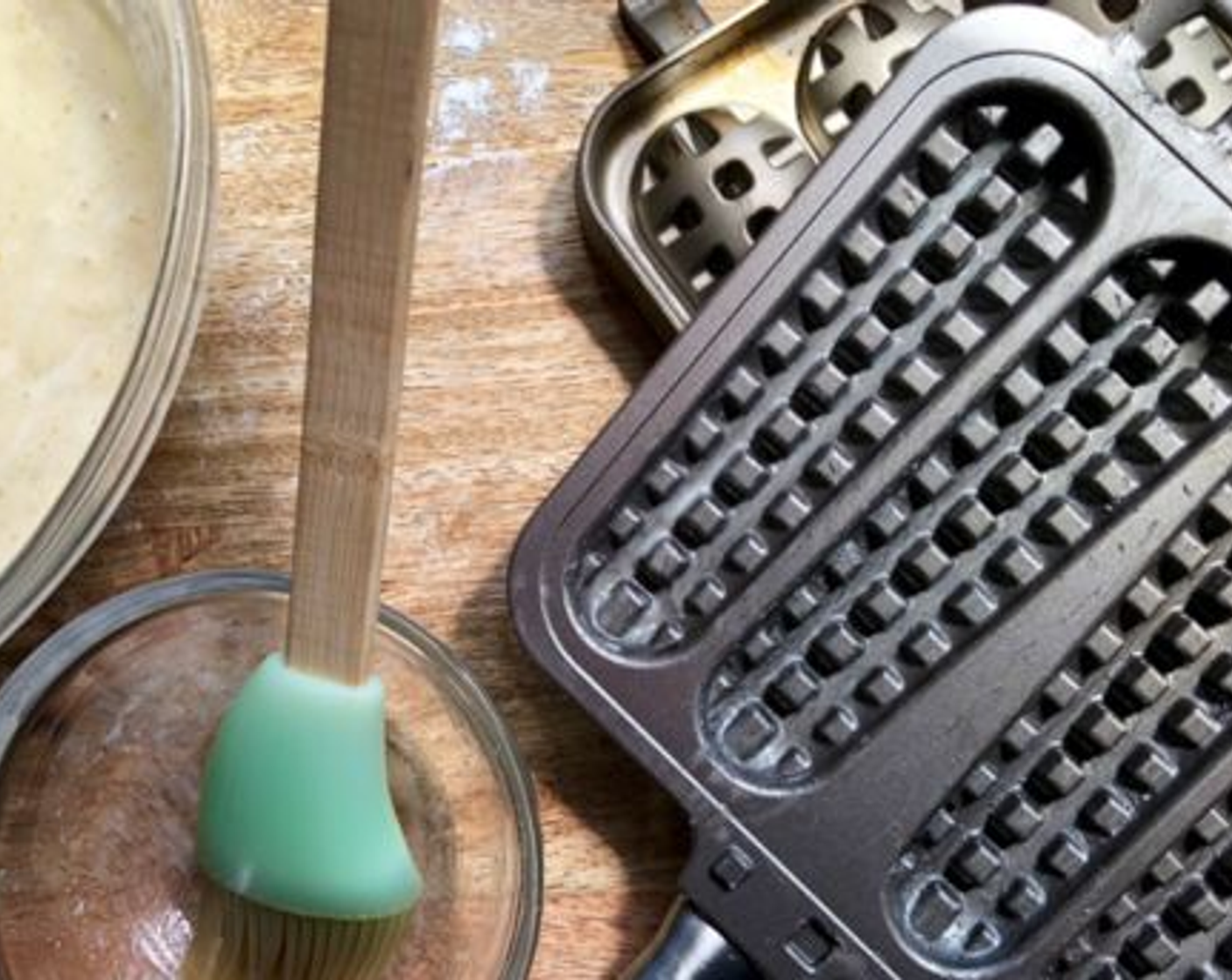 step 5 Lightly brush the inner surface of each pan with a small amount of melted butter or neutral oil. Preheat the outside of both pans on the stove over medium heat.