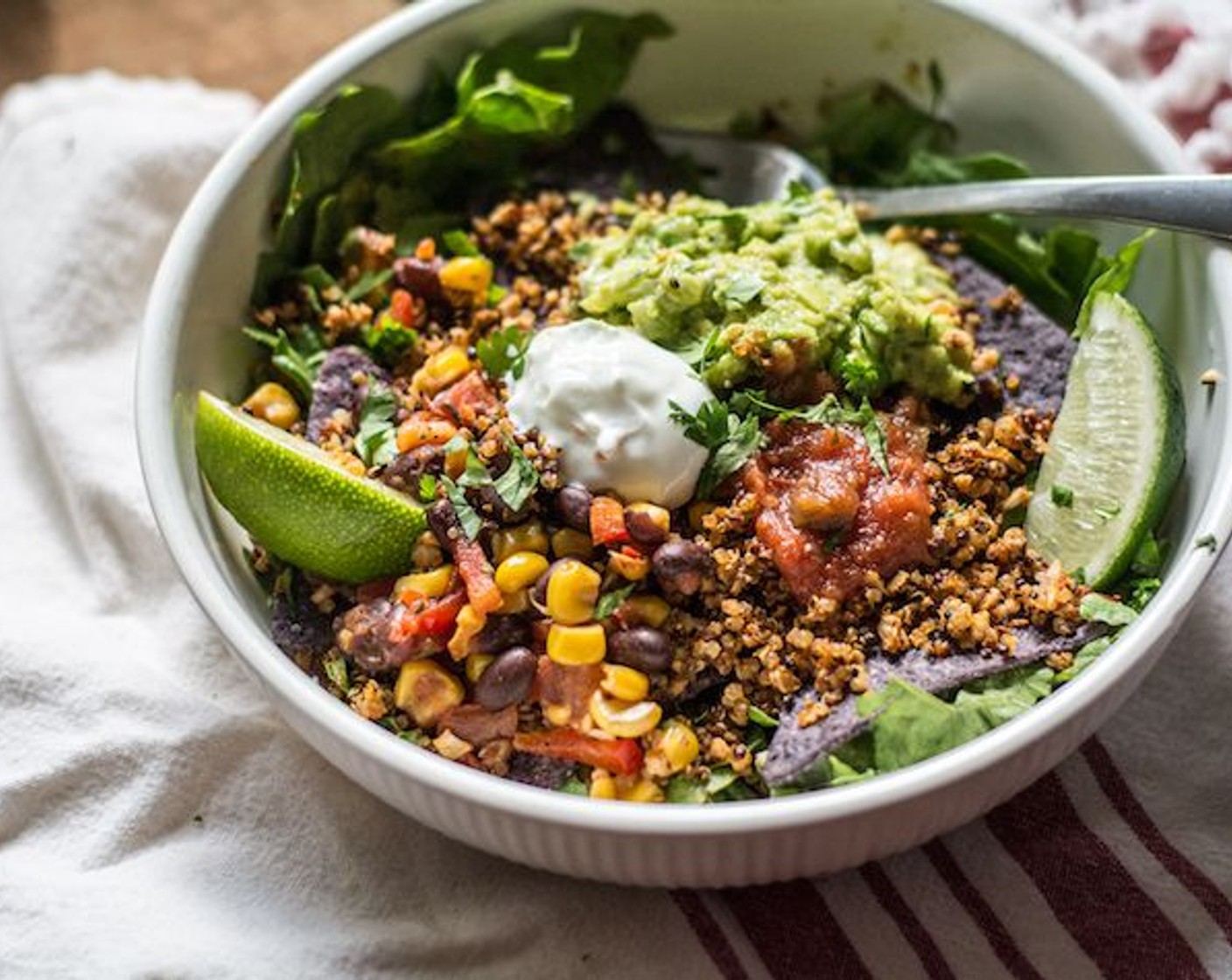 step 11 FOR TACO BOWL: Add a layer of fresh Romaine Lettuce (to taste) to medium bowl, followed by a layer Tortilla Chips (to taste) then a large scoop of cauliflower quinoa taco meat, guacamole, black bean corn salsa, and other desired toppings.