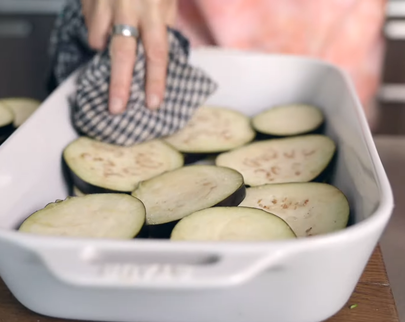 step 6 Pat off the excess moisture from the eggplant slices and remove them from the baking dish.