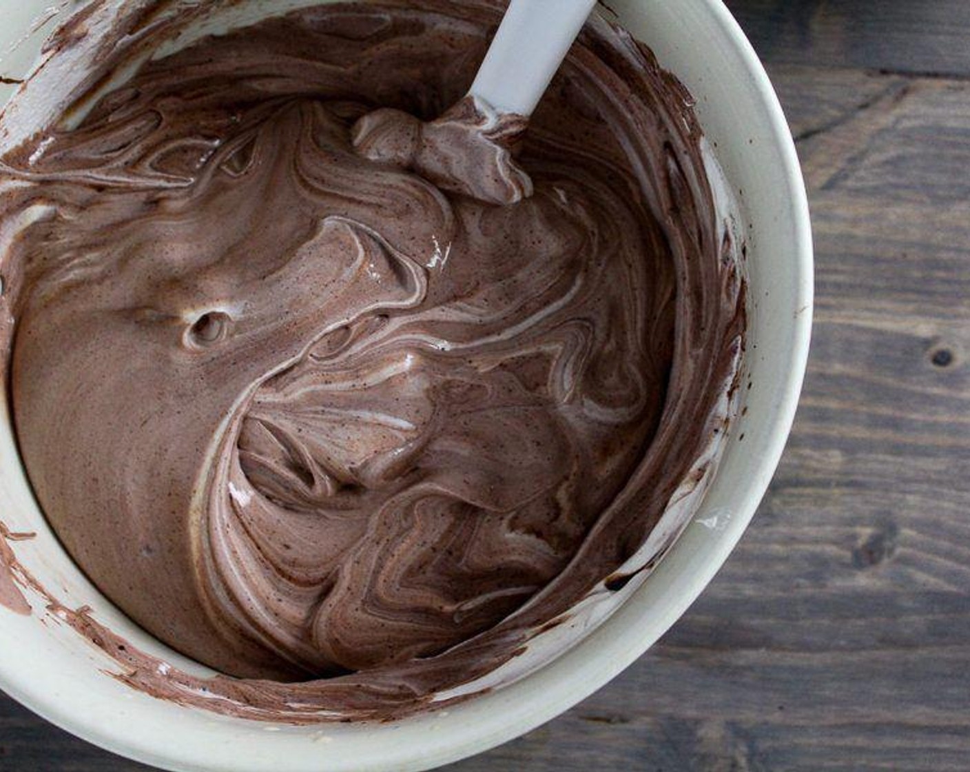 step 5 With a rubber spatula, gently fold in one tub of Whipped Topping (7 1/2 cups) and the Chocolate Syrup (3 Tbsp). Don't over stir.