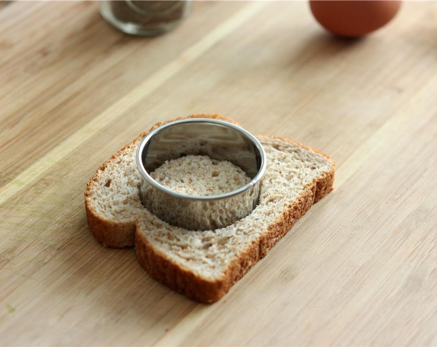 step 2 Use a round cookie cutter or biscuit cutter to cut a hole out of the Whole Wheat Bread (1 slice).
