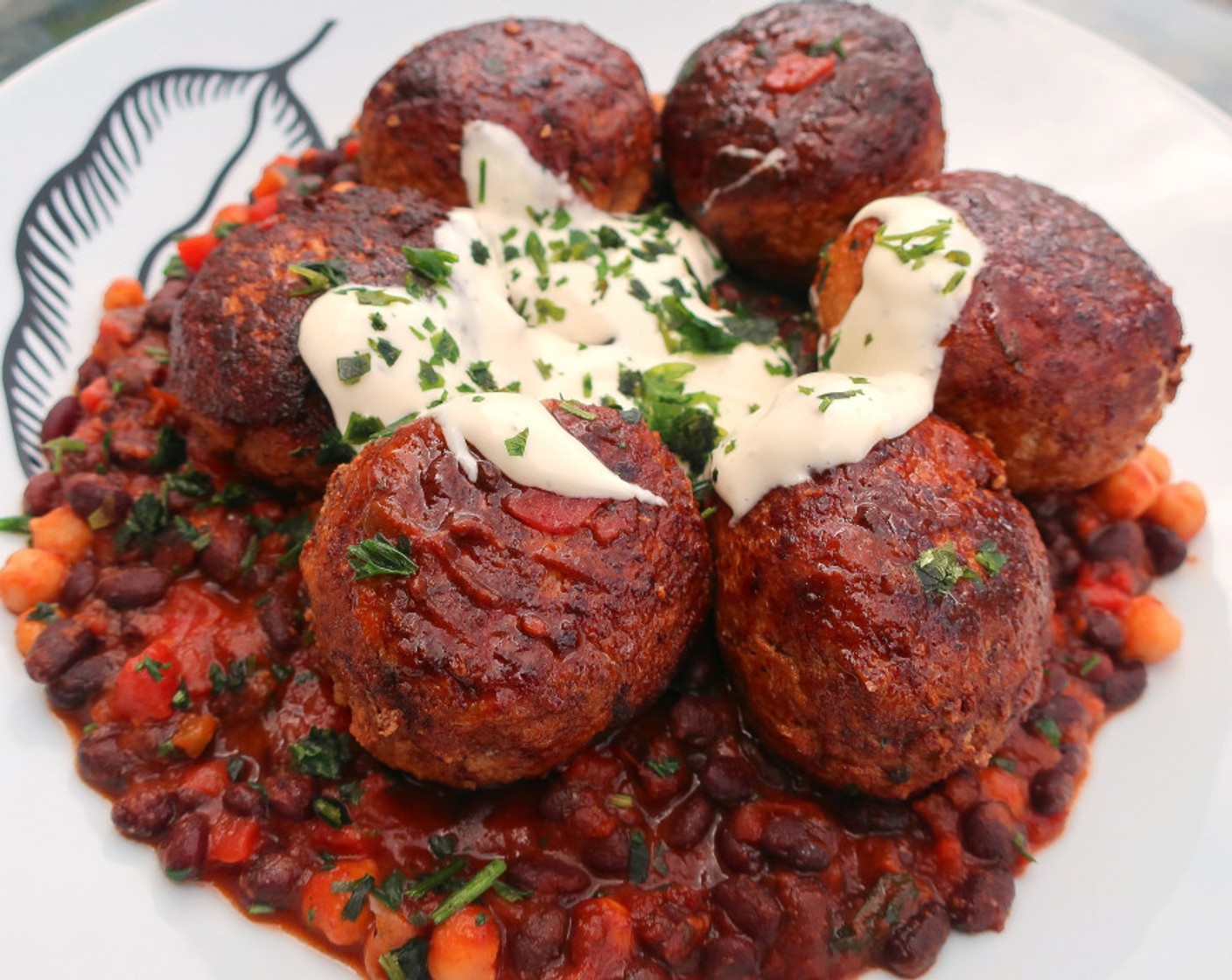 step 8 Top the beans with the meatballs, and drizzle over with garlic/herb yogurt. Serve and enjoy!