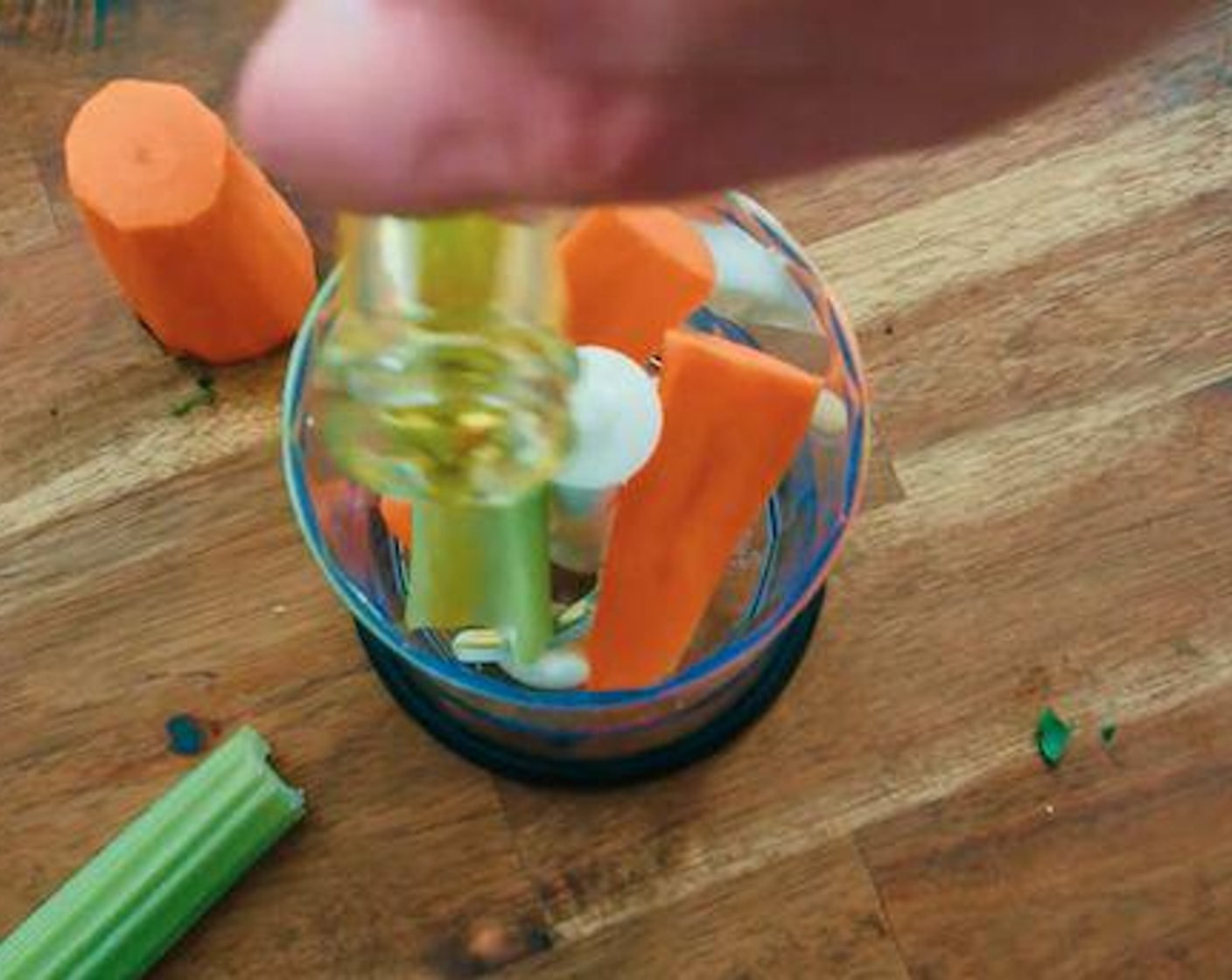 step 4 To make the Italian meatballs, put the Garlic (3 cloves), and the remaining half of the carrot and celery into a small hand blender. Mix them together with a heavy splash of Extra-Virgin Olive Oil (as needed) and blend until smooth.