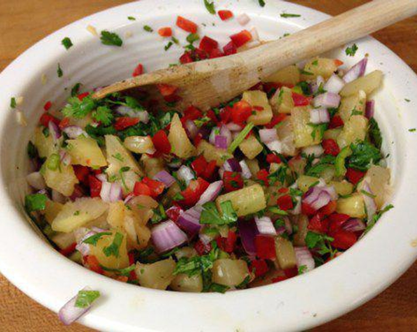 step 2 While the marinade is working put the salsa together. Combine Pineapple (1/2), Red Onion (1/2), Red Chili Pepper (1/2), Garlic (1 clove), Fresh Cilantro (1/4 cup), Serrano Chili (1), Limes (2), and All-Purpose Spice Rub (to taste) in a bowl and refrigerate.