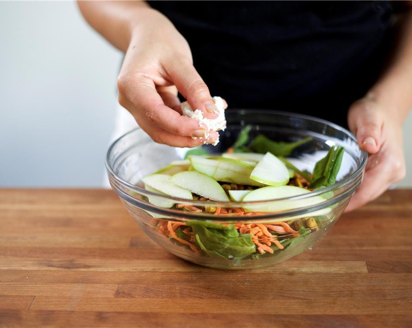 step 4 To the bowl with the vinaigrette, add the following ingredients in this order: Arugula (5 2/3 cups), matchstick carrots, Candied Pistachios (1 cup), and Granny Smith Apple. Hand crumble the Goat Cheese (1/2 cup) over the salad but wait to toss.