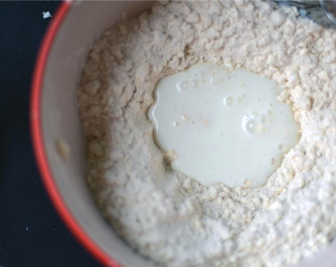 step 4 Remove from freezer and form a well in the center of the mixture and pour in Buttermilk (1/3 cup) all at once. With your hand or a fork, stir the flour into the buttermilk well.