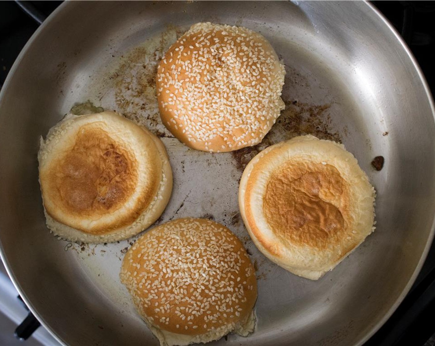 step 8 With the remaining oil in the pan, toast the Sesame Hamburger Buns (4) for 1 minute.  Add more oil if needed.