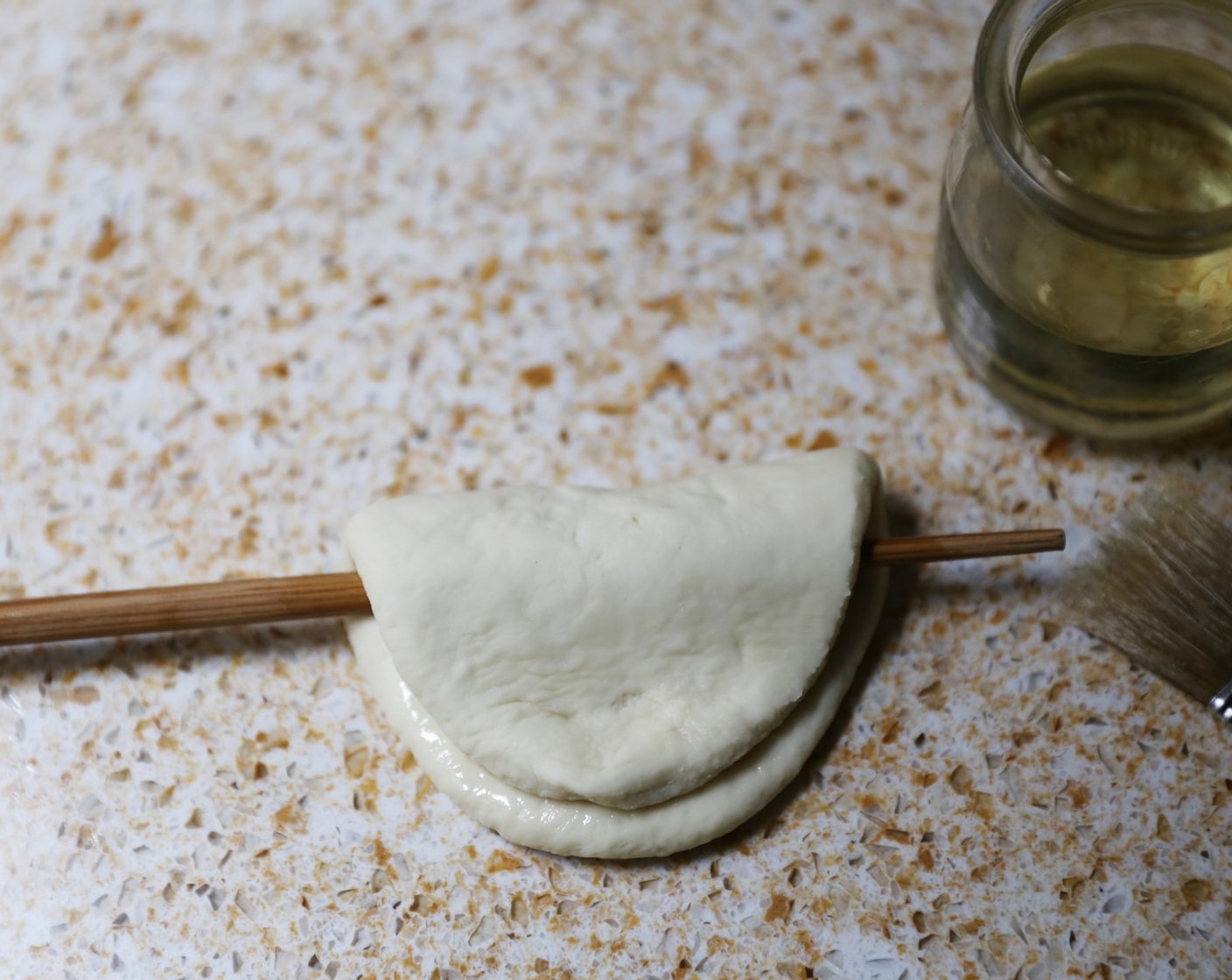 step 14 Fold the dough over the chopstick.