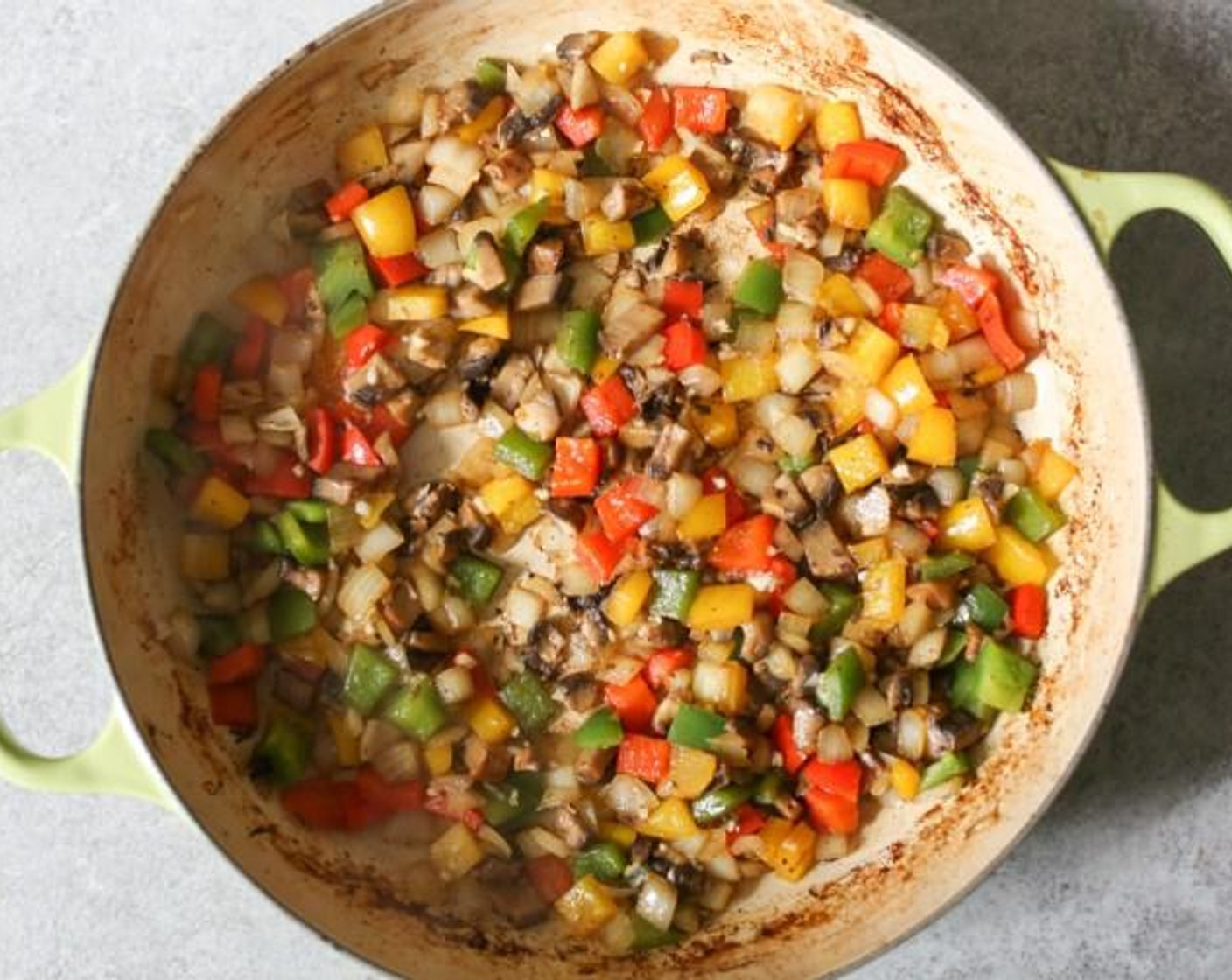 step 9 When the oil is hot, add the Bell Peppers (1 1/2), Yellow Onion (1), and Portabella Mushroom Caps (2) to the pan. Season with a tiny pinch of salt and freshly ground pepper, and cook for about 7 minutes until the vegetables are tender. Add the Worcestershire Sauce (2 Tbsp) and Low-Sodium Soy Sauce (2 Tbsp) and cook for 30 seconds more.