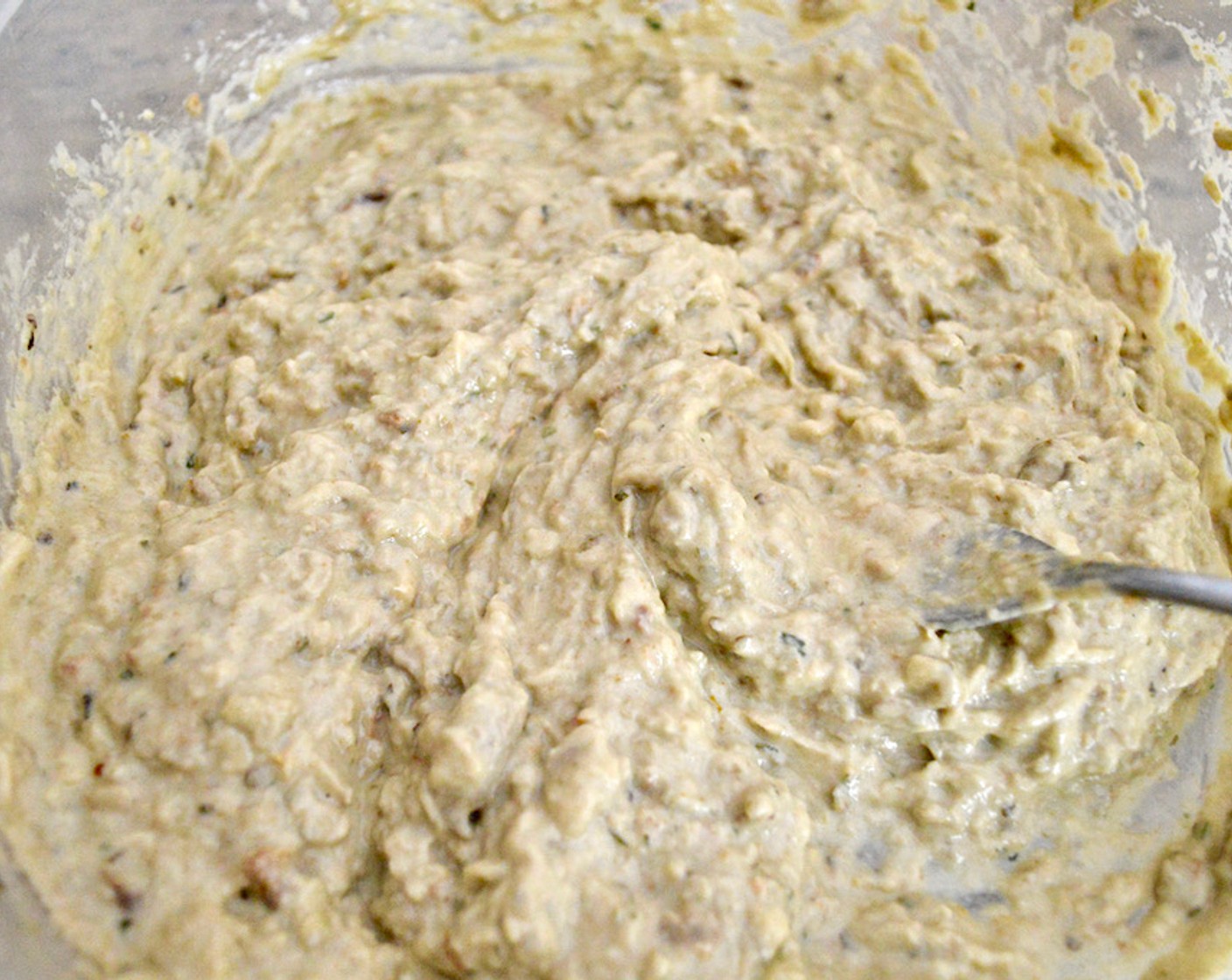 step 6 Stir in the Lemon (1), Tahini (1/4 cup), and Garlic (5 cloves). Mash with a fork until everything comes together. Then, slowly pour in Olive Oil (1/3 cup), keep stirring until it’s incorporated into a creamy mixture.