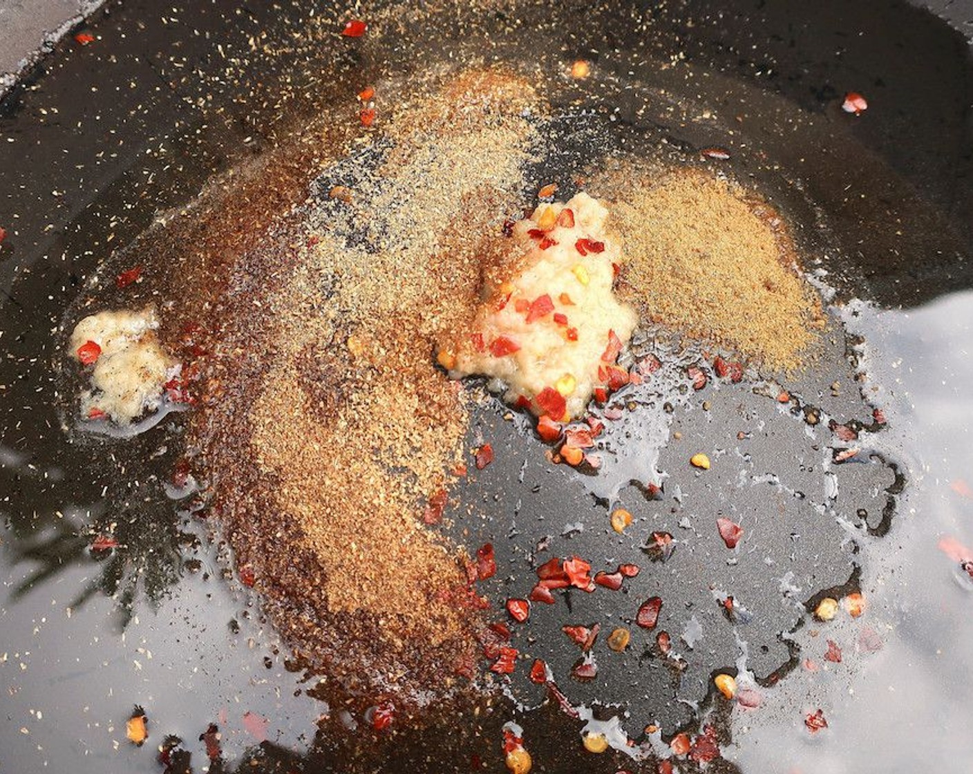 step 9 In a sauce pan, saute Garlic Paste (1 Tbsp), Ginger Paste (1/2 tsp), Crushed Red Pepper Flakes (1/2 tsp), Garam Masala (1 Tbsp), Ground Turmeric (1 Tbsp), Ground Cumin (1/2 tsp), and Ground Coriander (1/2 tsp) in Ghee (3 Tbsp) until fragrant.