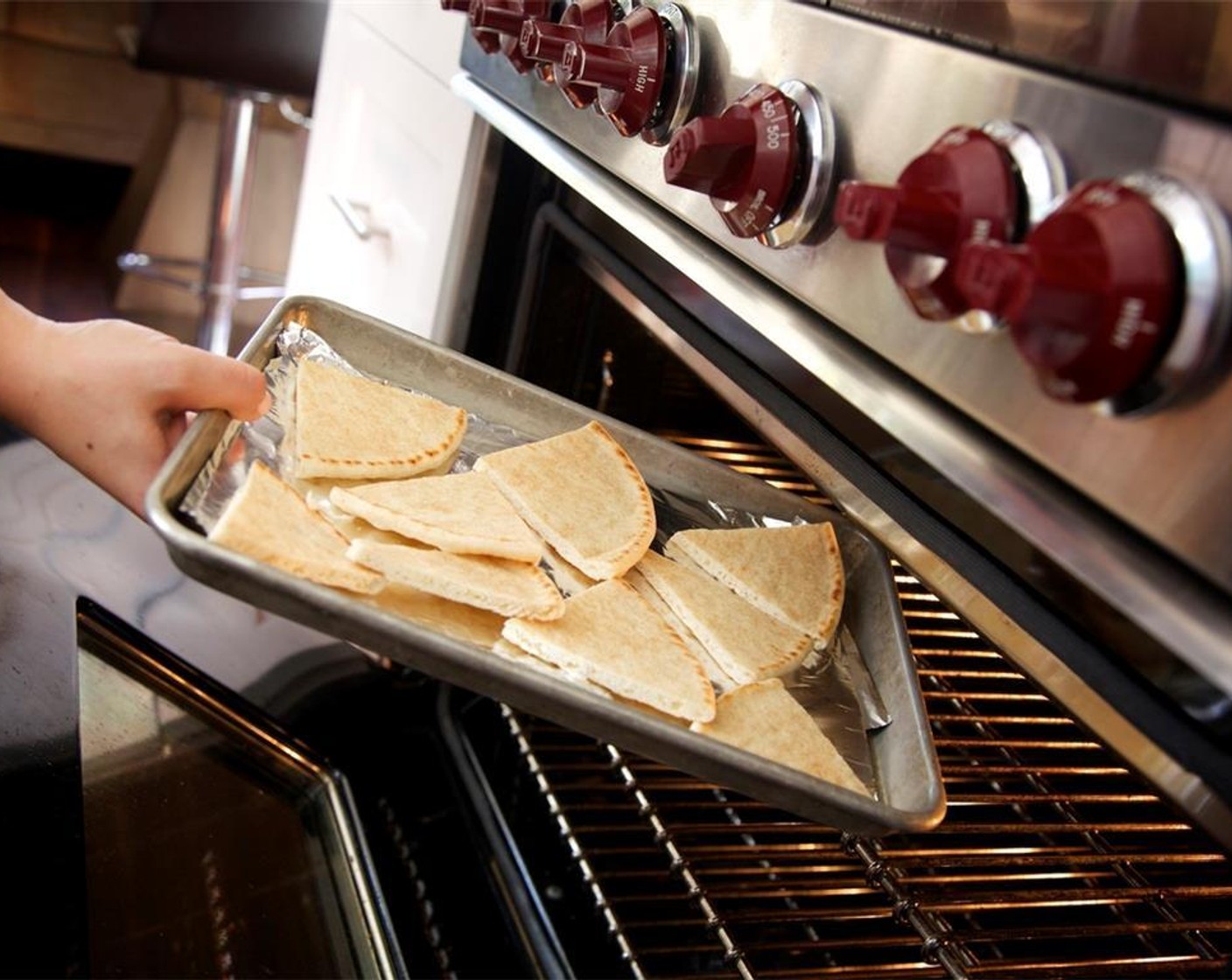 step 14 Place the pita triangles into the oven and warm for 5 minutes, then remove from the oven. Meanwhile, heat a medium sauté pan over medium high heat.