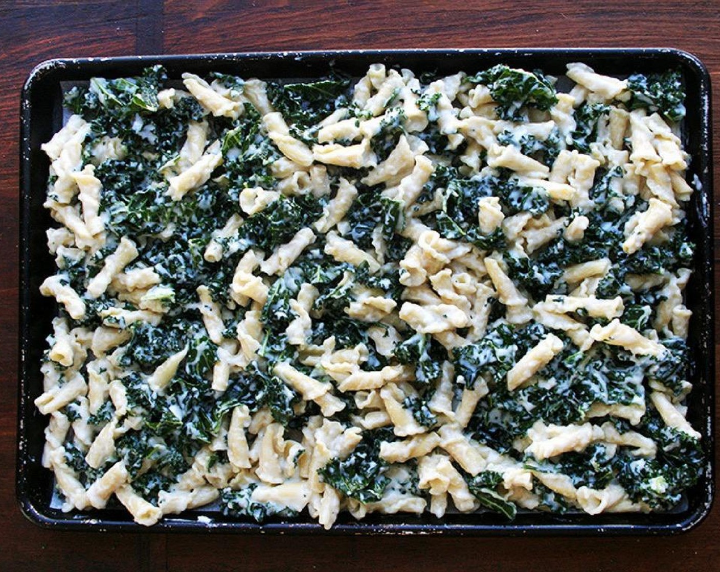 step 4 Line a rimmed sheet pan with a sheet of parchment paper. Spread macaroni mixture over top. Distribute Fontina Cheese (1 1/2 cups) over the top.