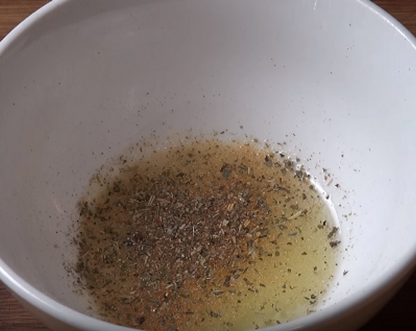 step 2 In a small bowl or cup, add Olive Oil (2 Tbsp), Simply Organic Garlic Powder (1 dash), Simply Organic Onion Powder (1 dash), and some Dried Mixed Herbs (to taste). Mix well.
