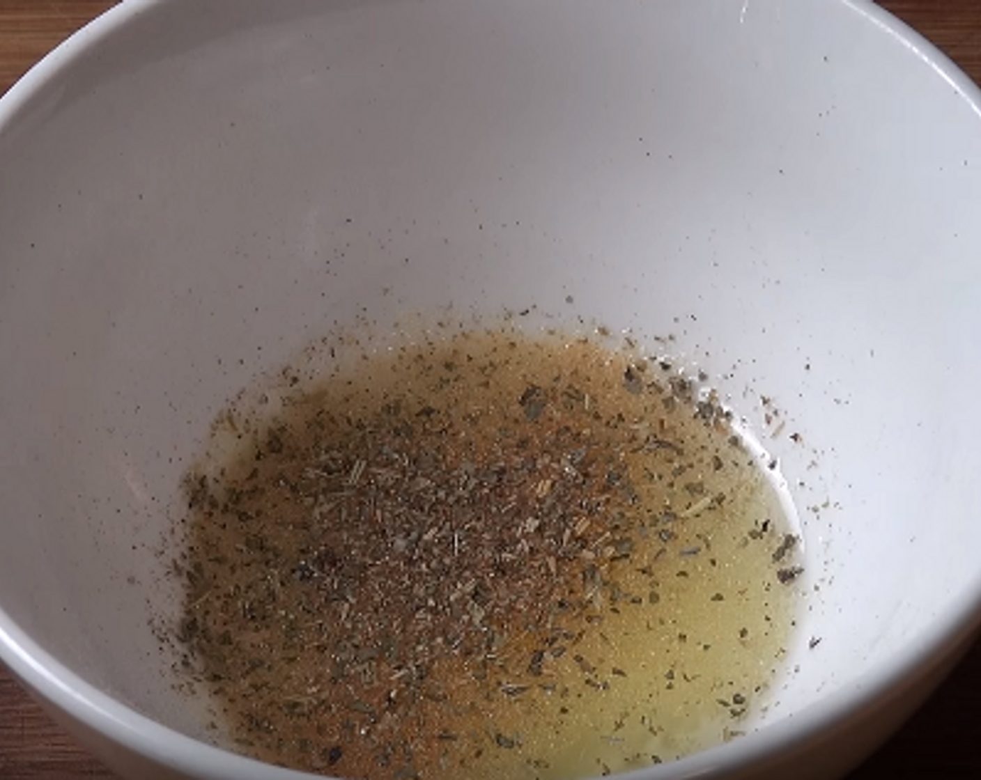 step 2 In a small bowl or cup, add Olive Oil (2 Tbsp), McCormick® Garlic Powder (1 dash), Onion Powder (1 dash), and some Dried Mixed Herbs (to taste). Mix well.