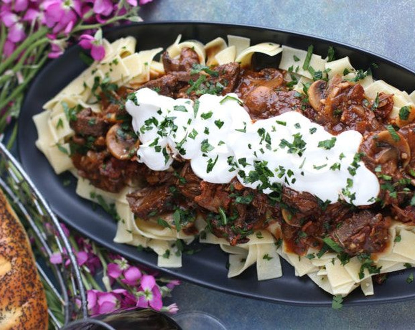 step 24 To serve, ladle meat/mushroom sauce over buttered pappardelle noodles, garnish with dollop of creme fraiche and sprinkle with Fresh Parsley (1/4 cup). Serve immediately.