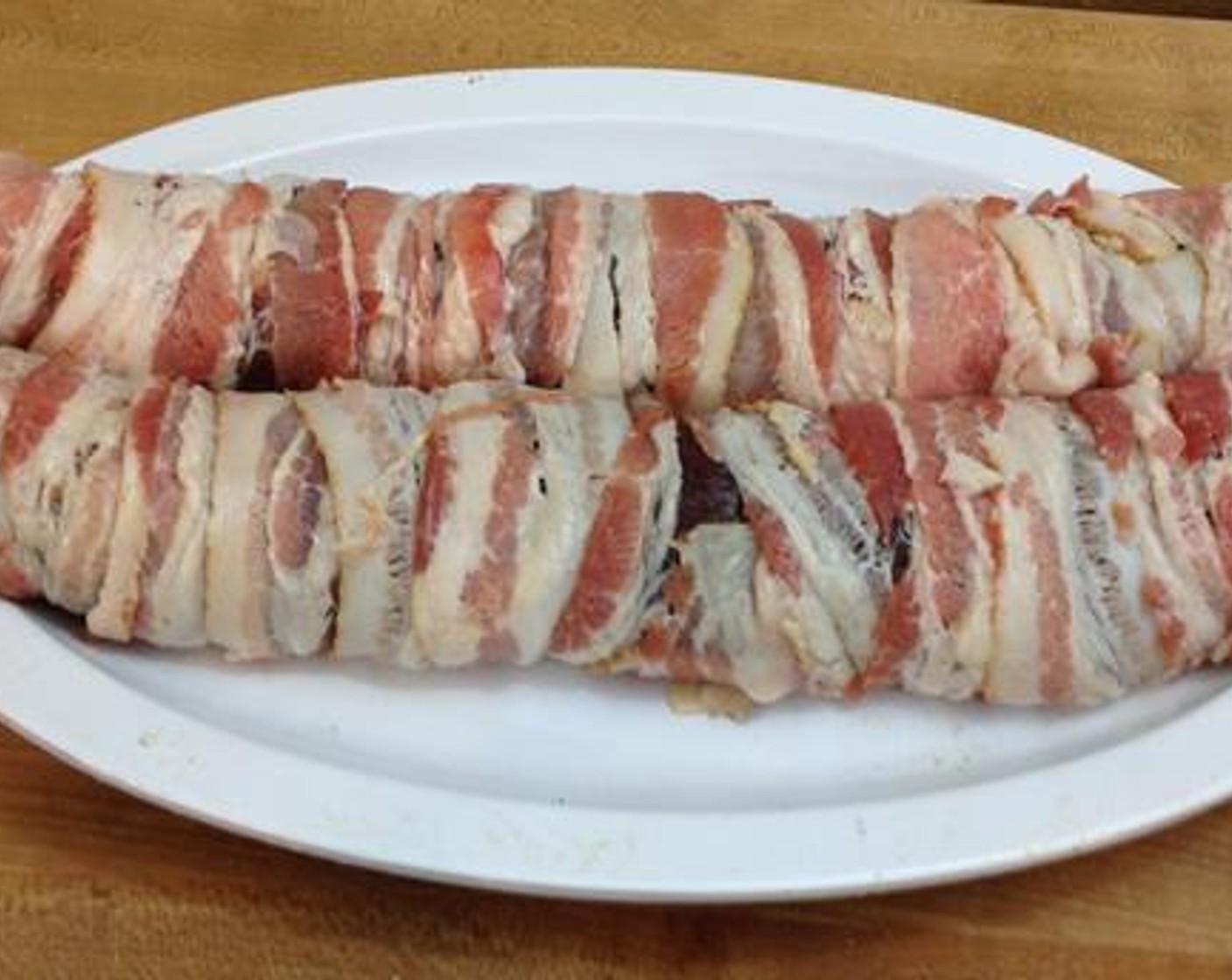 step 2 Start at one end of the strap and roll the bacon around overlapping each pass. Continue doing this down the length of the venison backstrap.