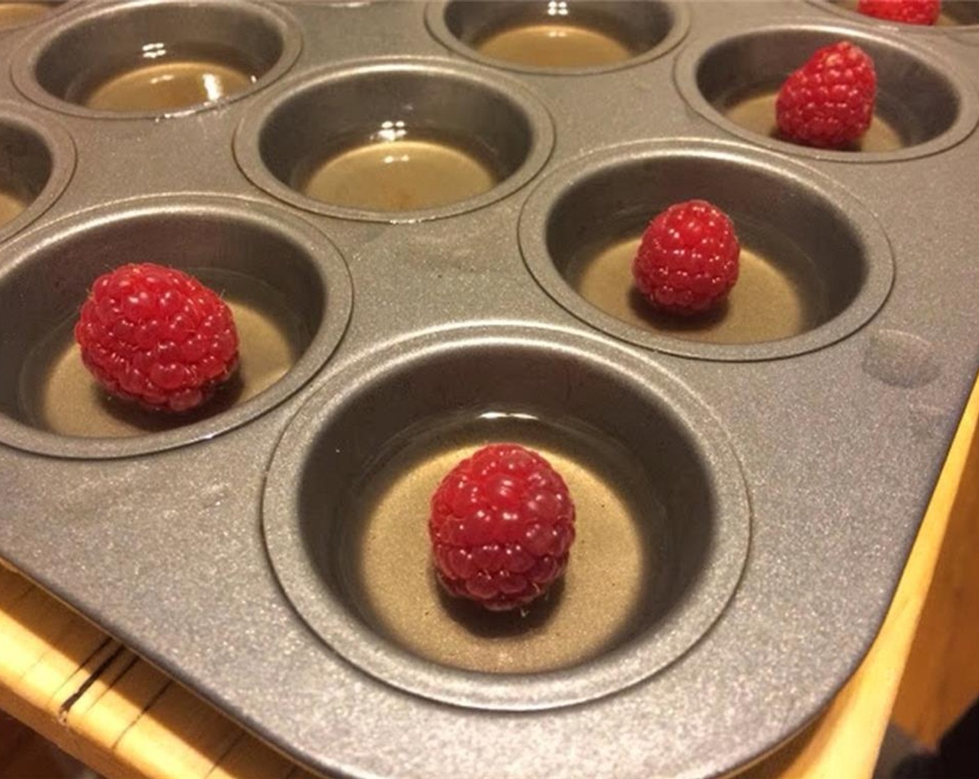 step 4 Remove from heat and pour in the remaining 1 3/4 cups of champagne and the Framboise Liqueur (1/4 cup). Transfer to something with a pour spout. Fill muffin pan about 1/3 to half full. Place in refrigerator to lightly set, for 15 minutes.