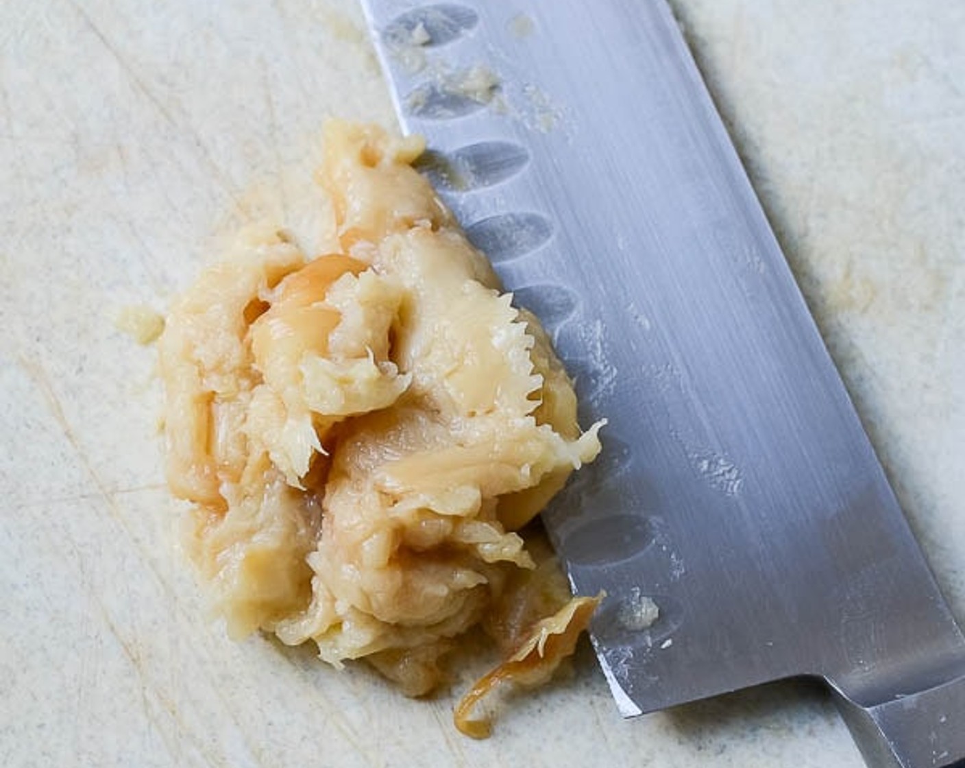 step 7 Peel apart the garlic once cooled. Holding a clove of garlic from the bottom, squeeze out the roasted garlic onto a cutting board. Repeat for each clove. Chop the cloves roughly and use the side of the knife to smear the garlic into a paste.