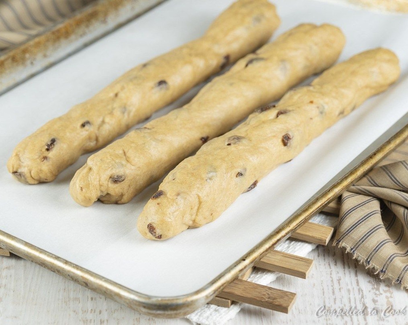 step 8 Roll each third into a 14-inch long log. Lay the 3 logs parallel to each other on the baking tray.