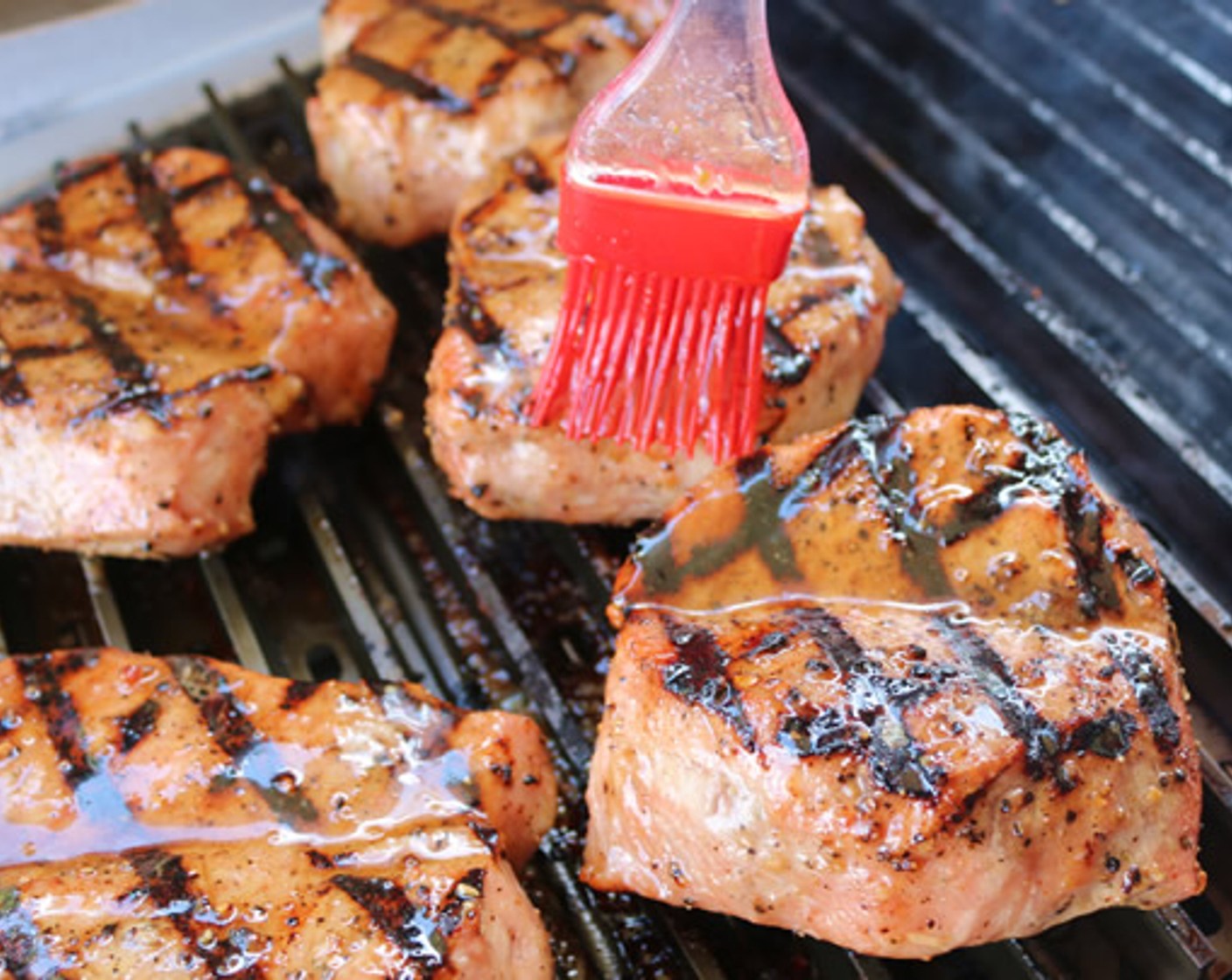 step 8 Place each chop over the direct heat side of the grill and baste with the Bourbon Butter mixture. Remove from heat once the internal temperature reaches 135 degrees F (57 degrees C) instant read thermometer.