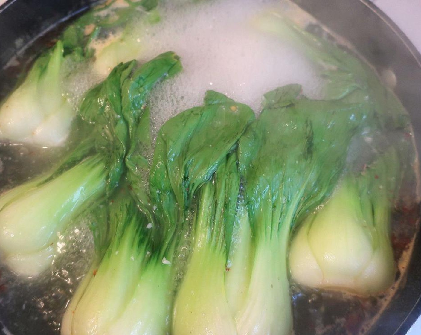 step 2 Simmer for 30 seconds more, drain and discard the water, place bok choy into ice water.