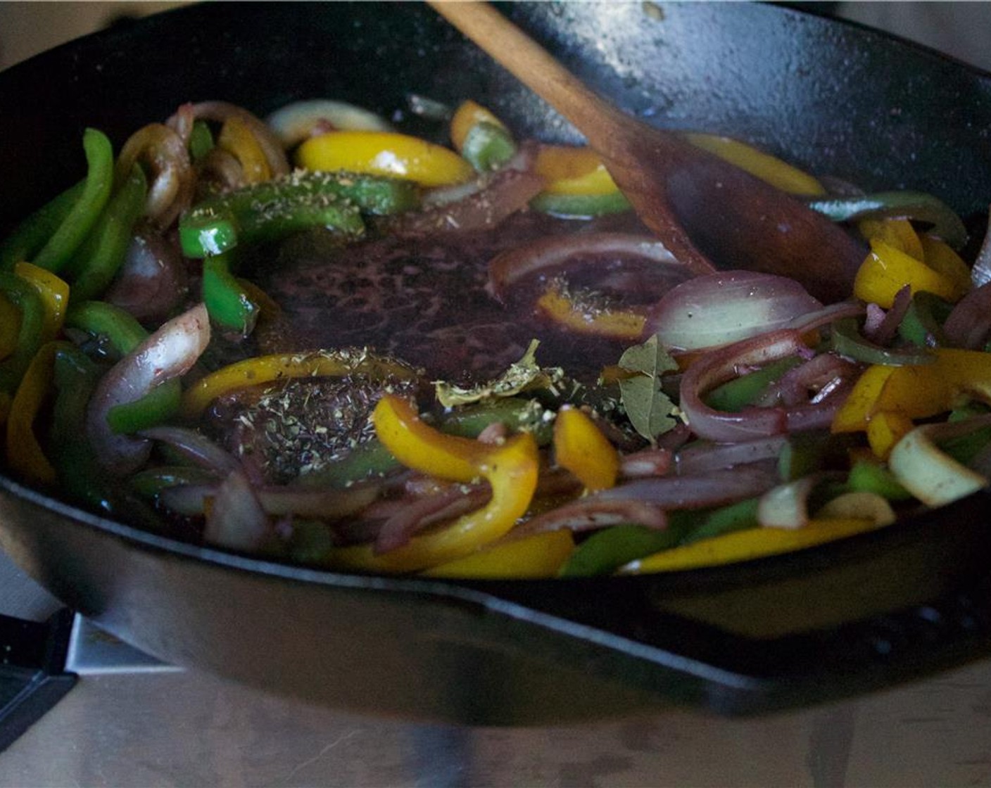 step 9 Once garlic is fragrant, add in the Bay Leaf (1) and Dried Oregano (1/2 tsp), and deglaze with Red Wine (1 cup). Scrape the brown bits from the bottom of the pan. Bring to a boil and reduce the wine by half.